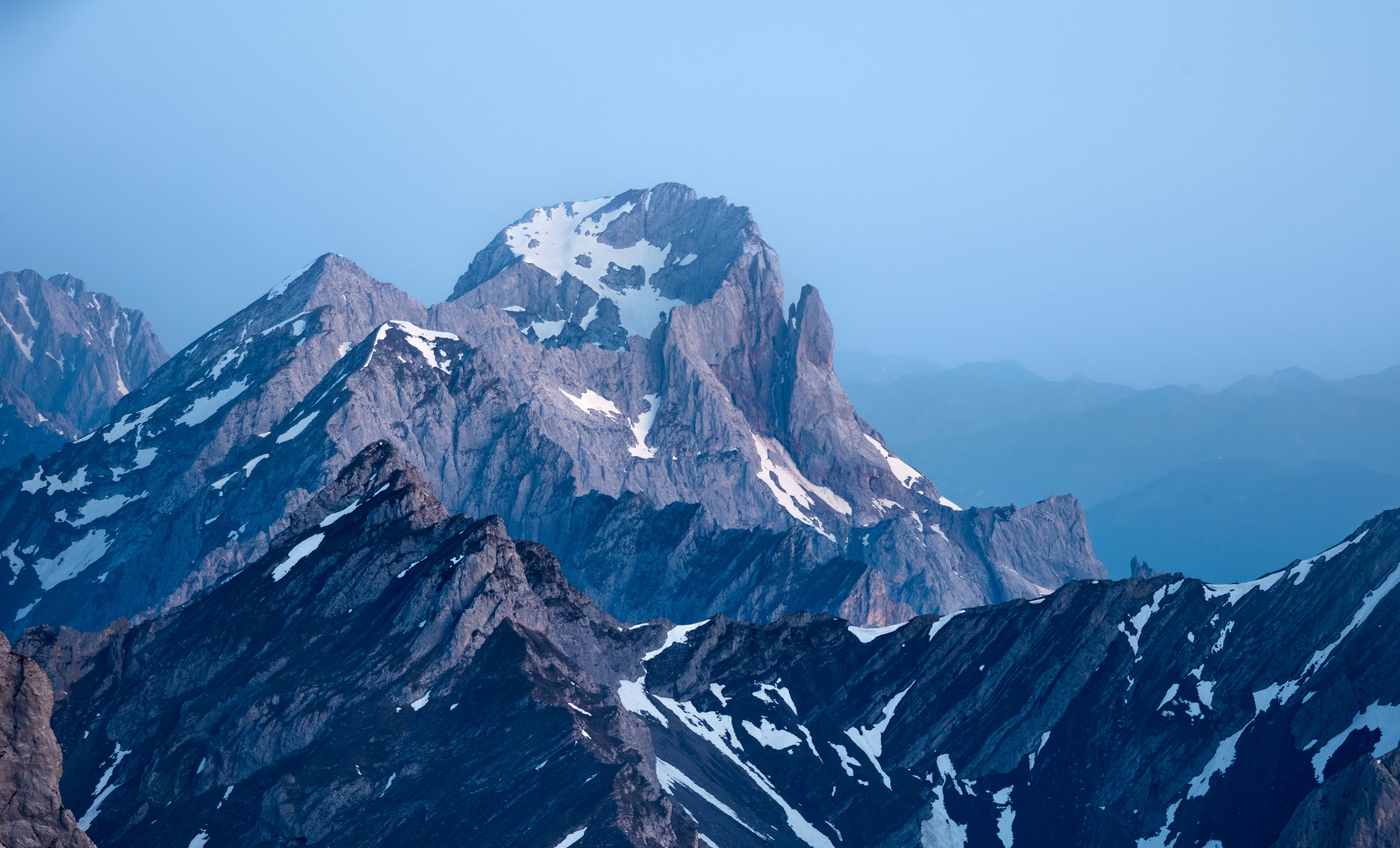 Jagged mountain peaks with snow under a clear sky