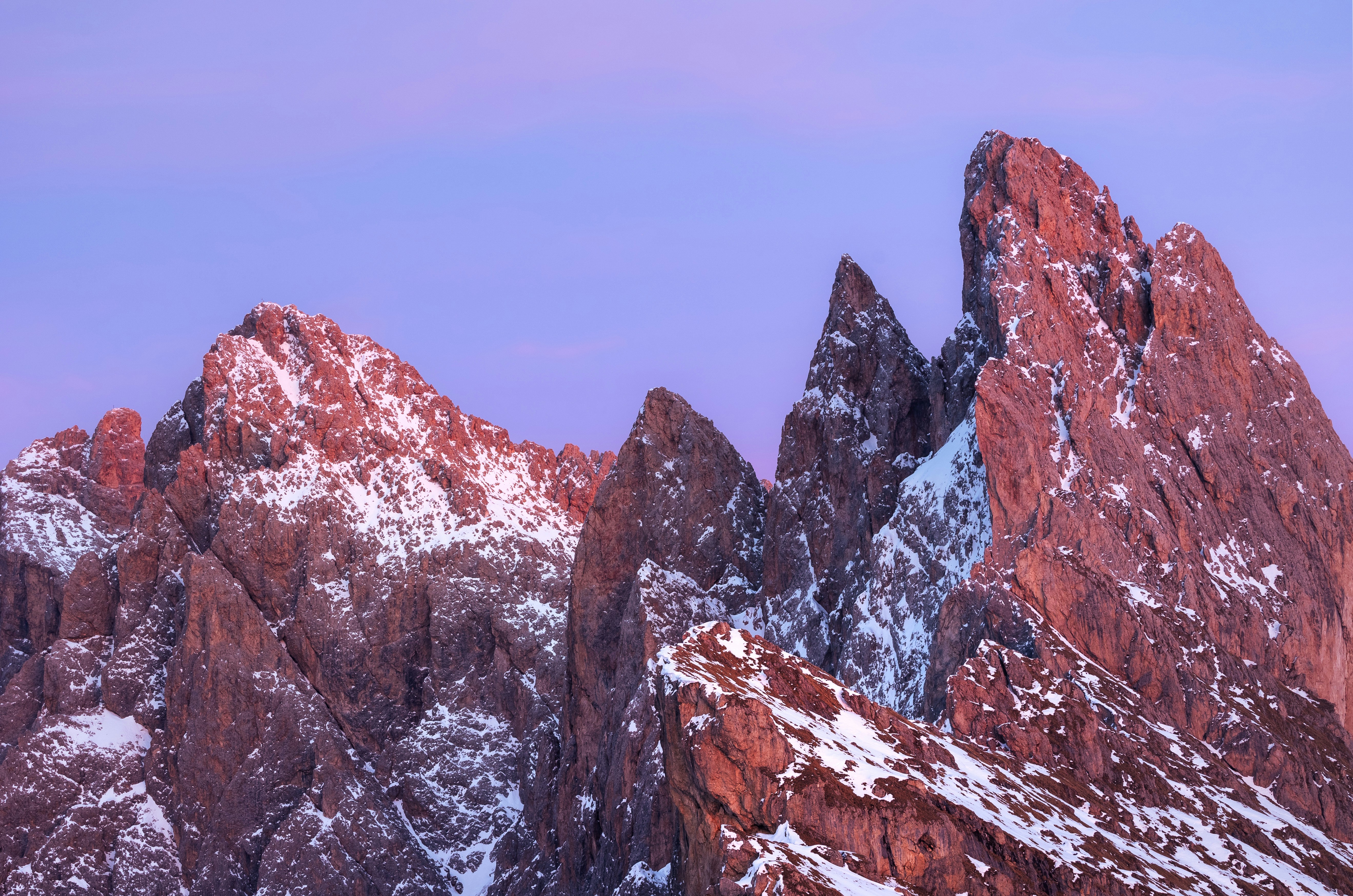 Jagged mountain peaks with snow at sunrise