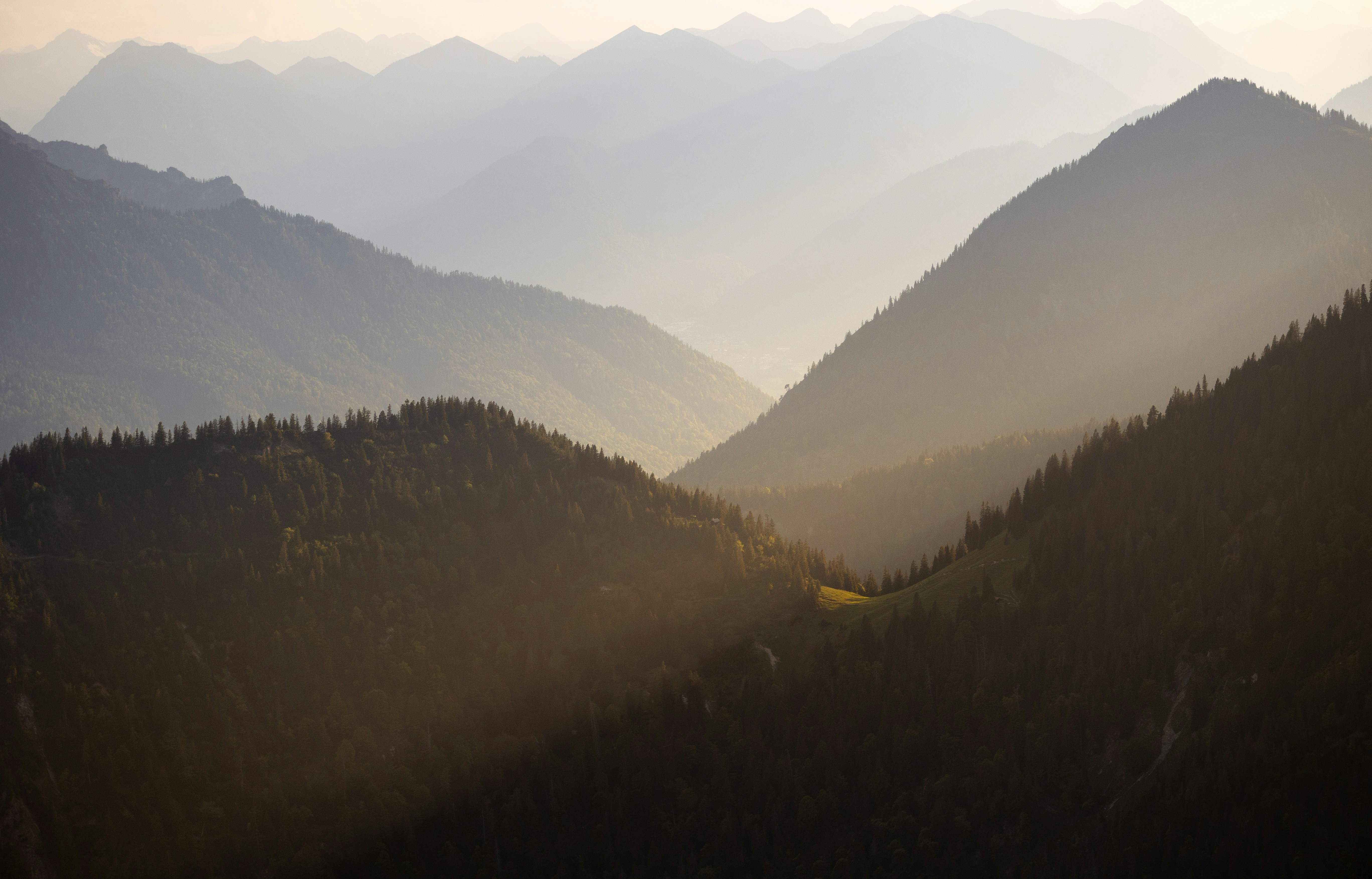 Layered mountain ranges bathed in soft morning light.