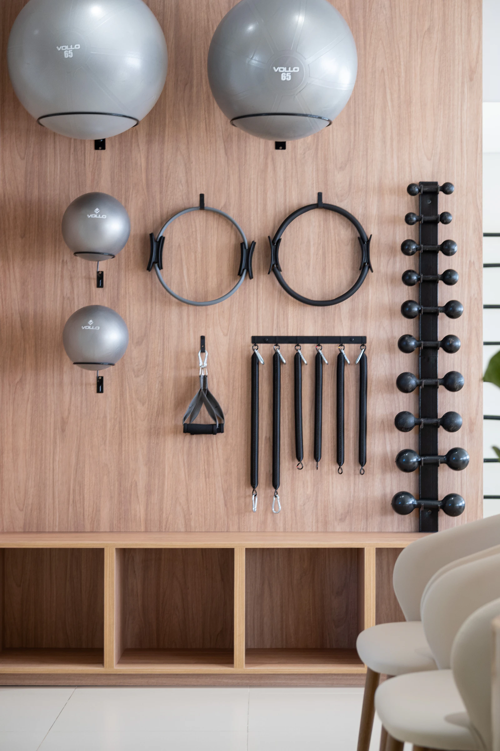 Home gym with equipment neatly organised against a wall