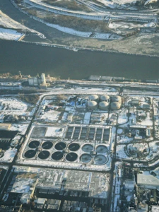 Aerial view of industrial complex by river in winter