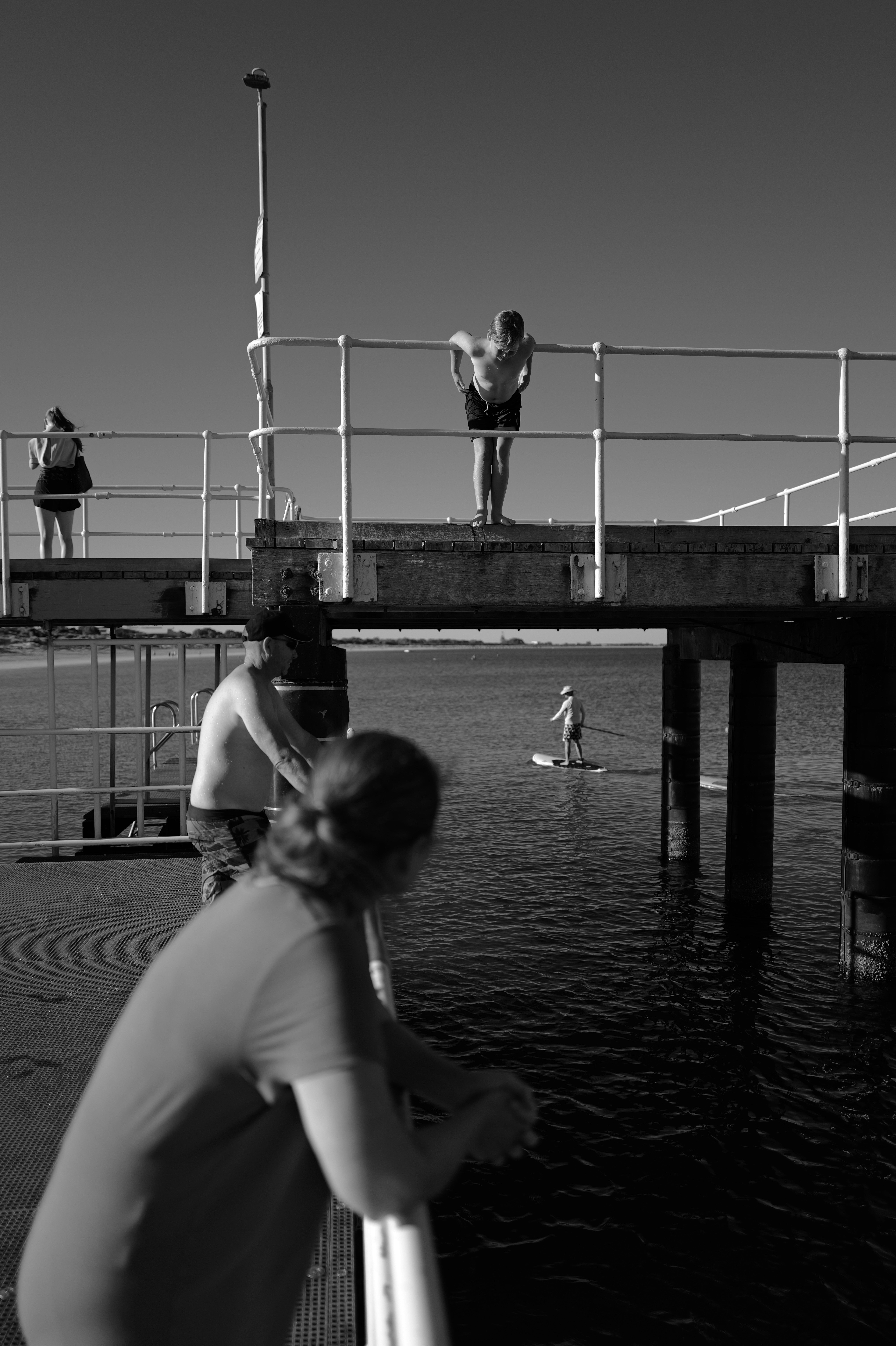 People on a pier overlooking the water
