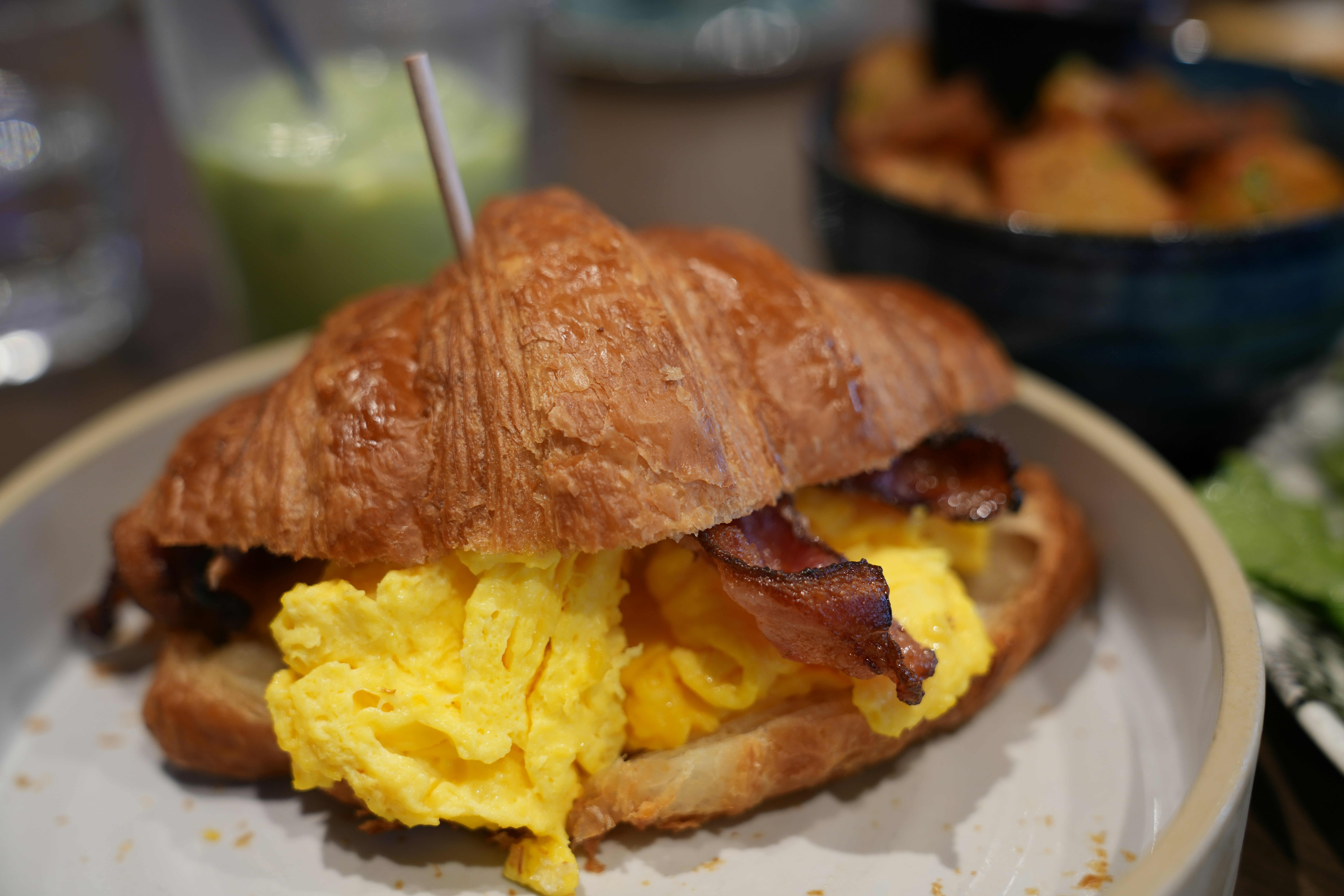 Croissant sandwich with scrambled eggs and bacon