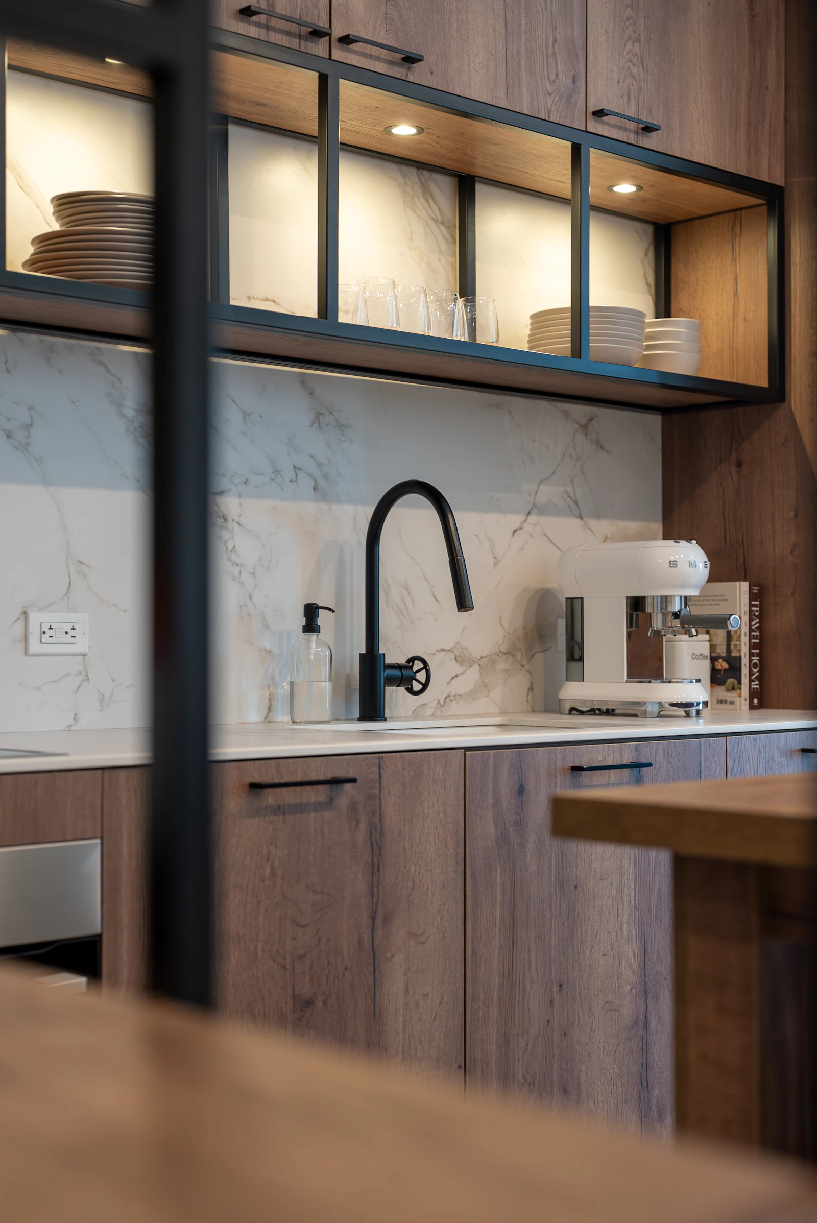 Kitchen with warm wood cabinetry and marble backsplash