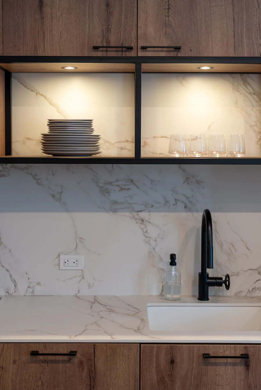 A bright, tidy kitchen sink area with dark fixtures