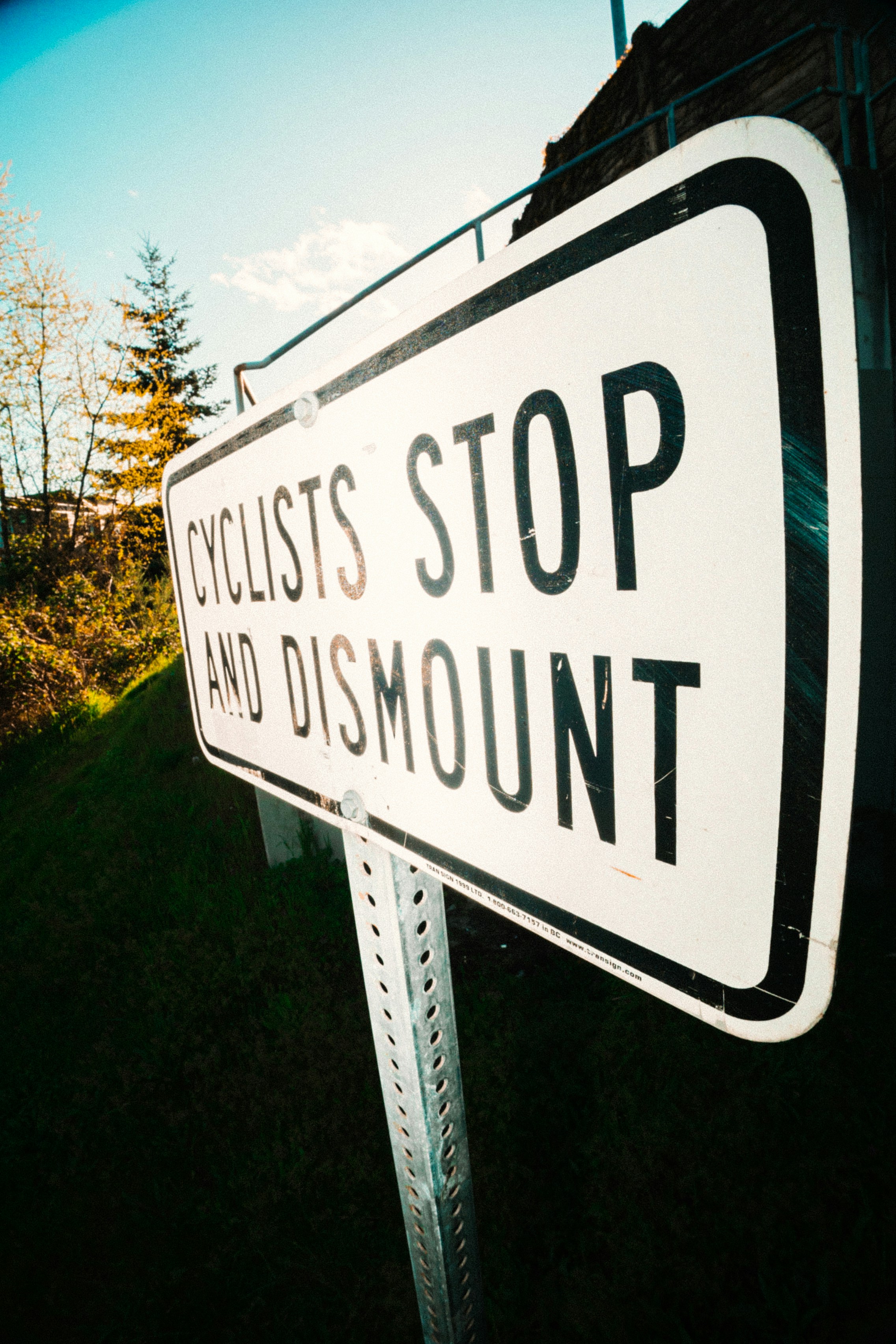 Cyclists stop and dismount sign
