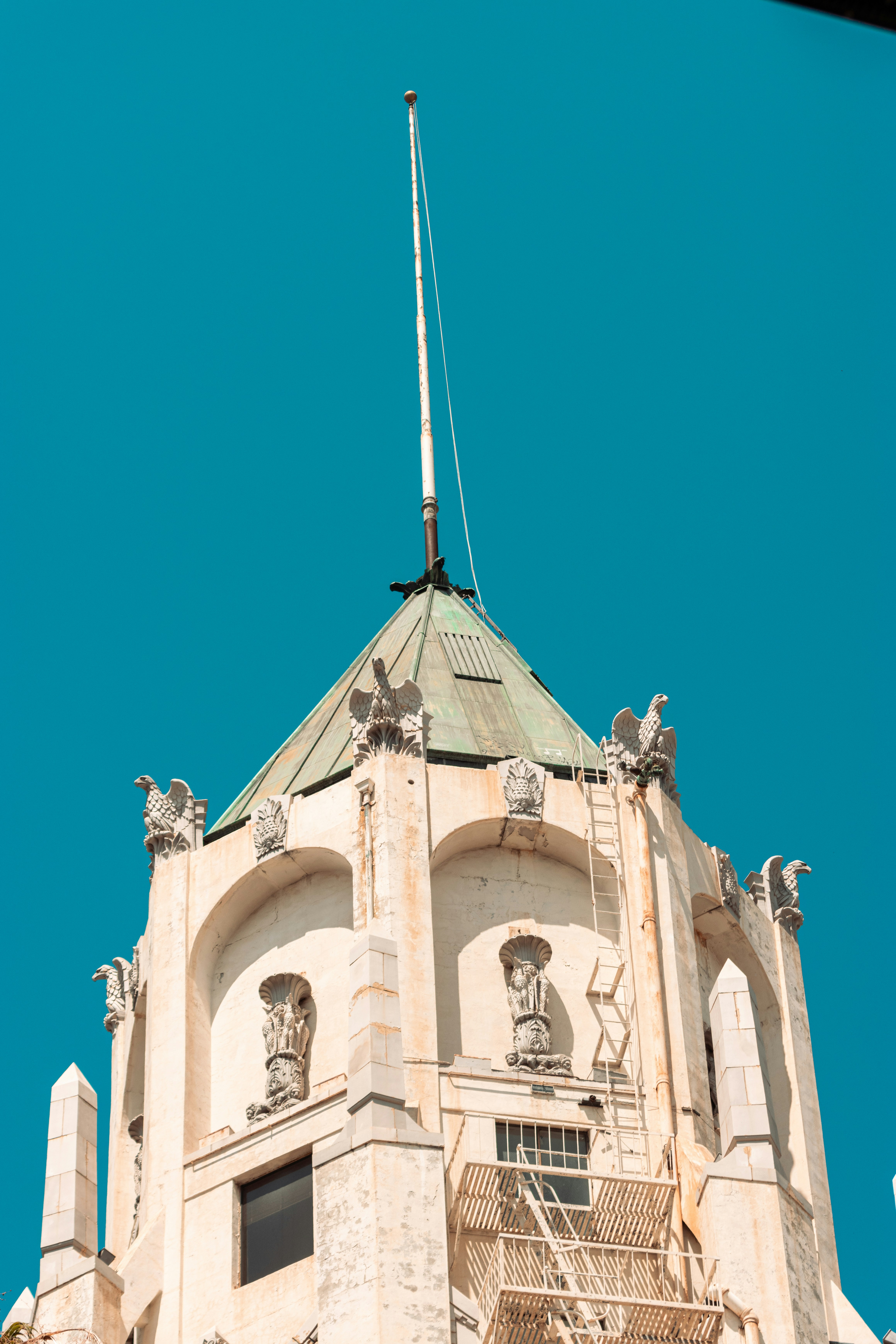 Art deco building with eagle gargoyles against blue sky