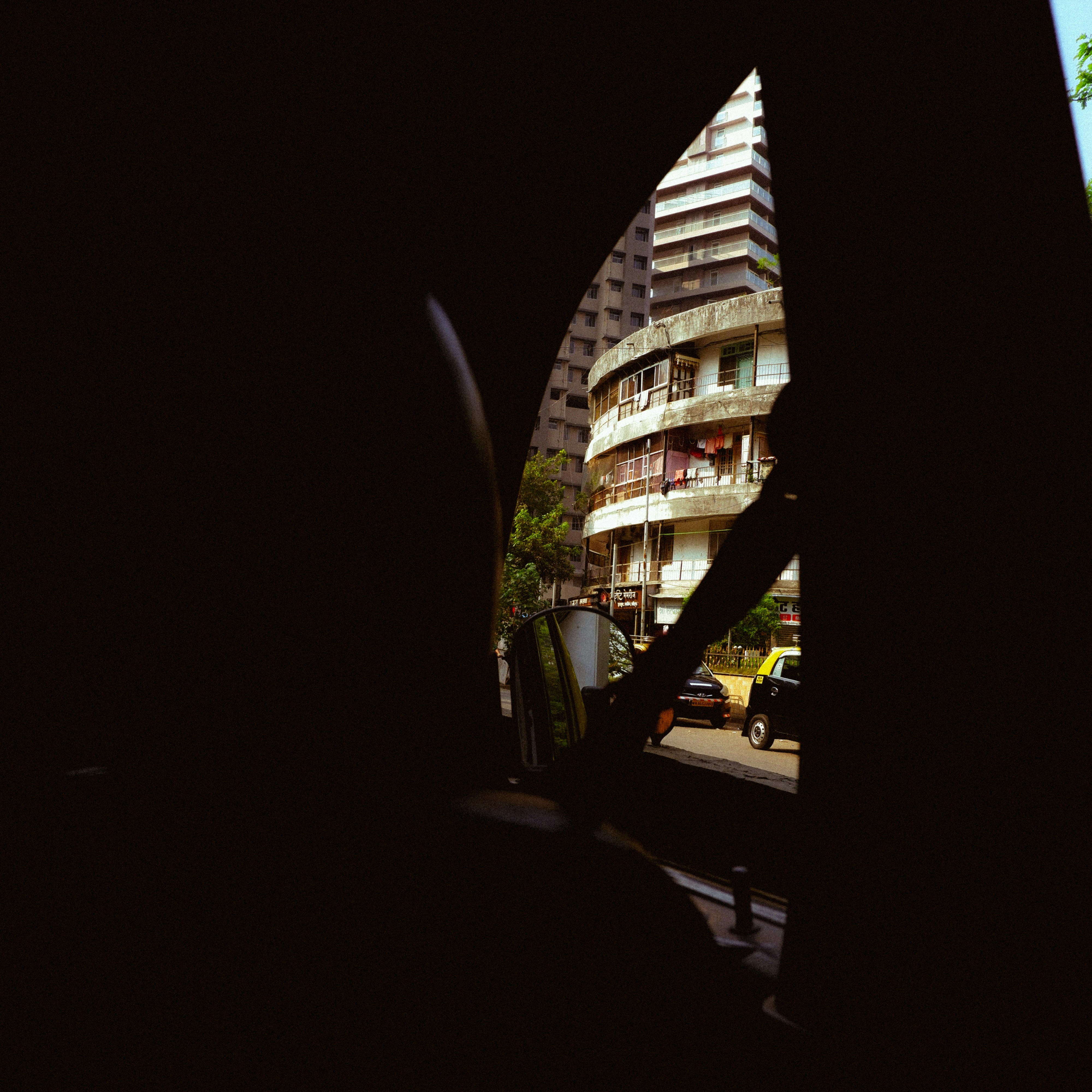 View of buildings through a dark archway