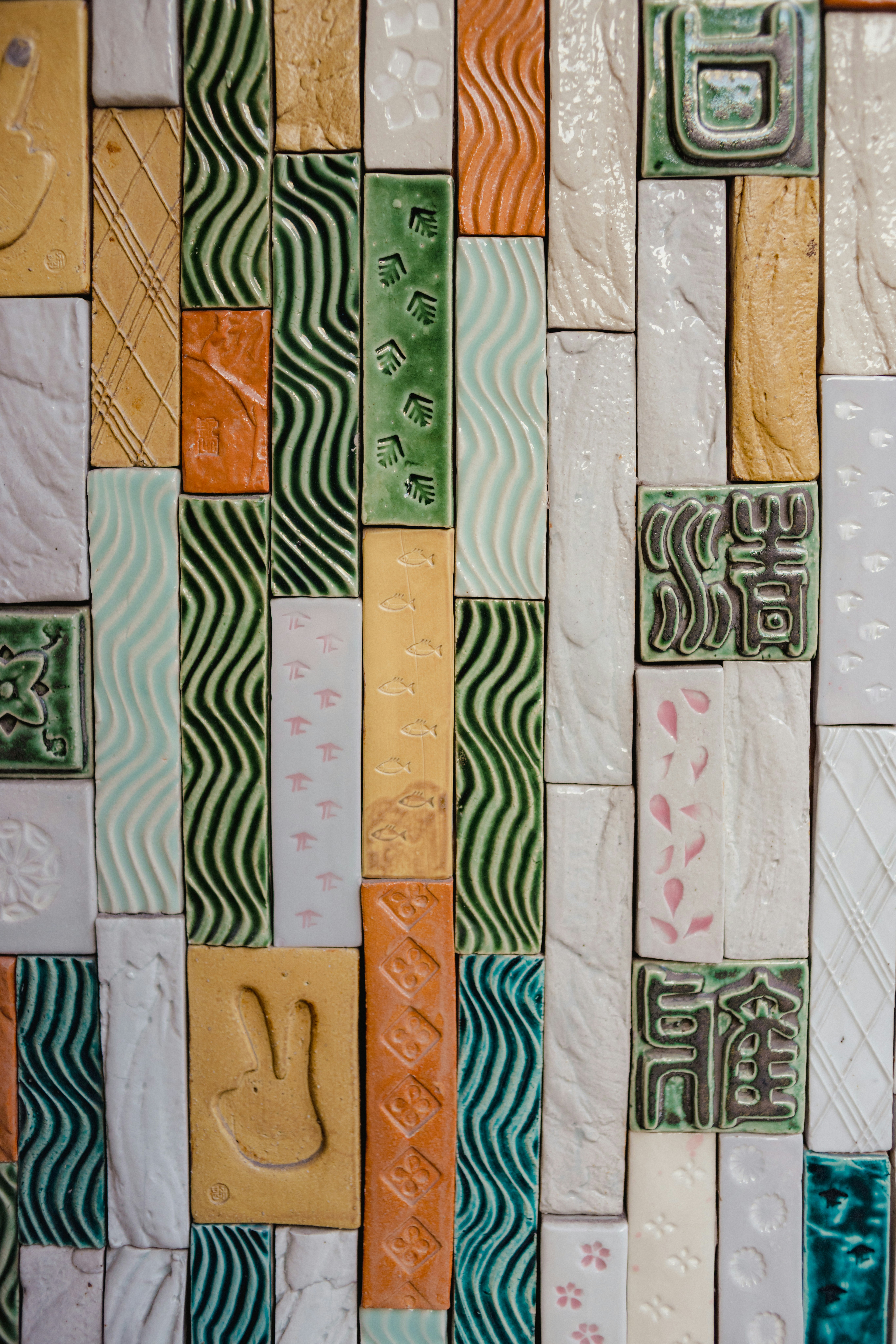 A colorful wall of textured ceramic tiles