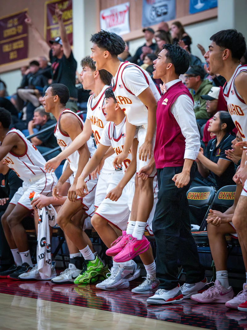 Basketball team celebrating on the bench during a game