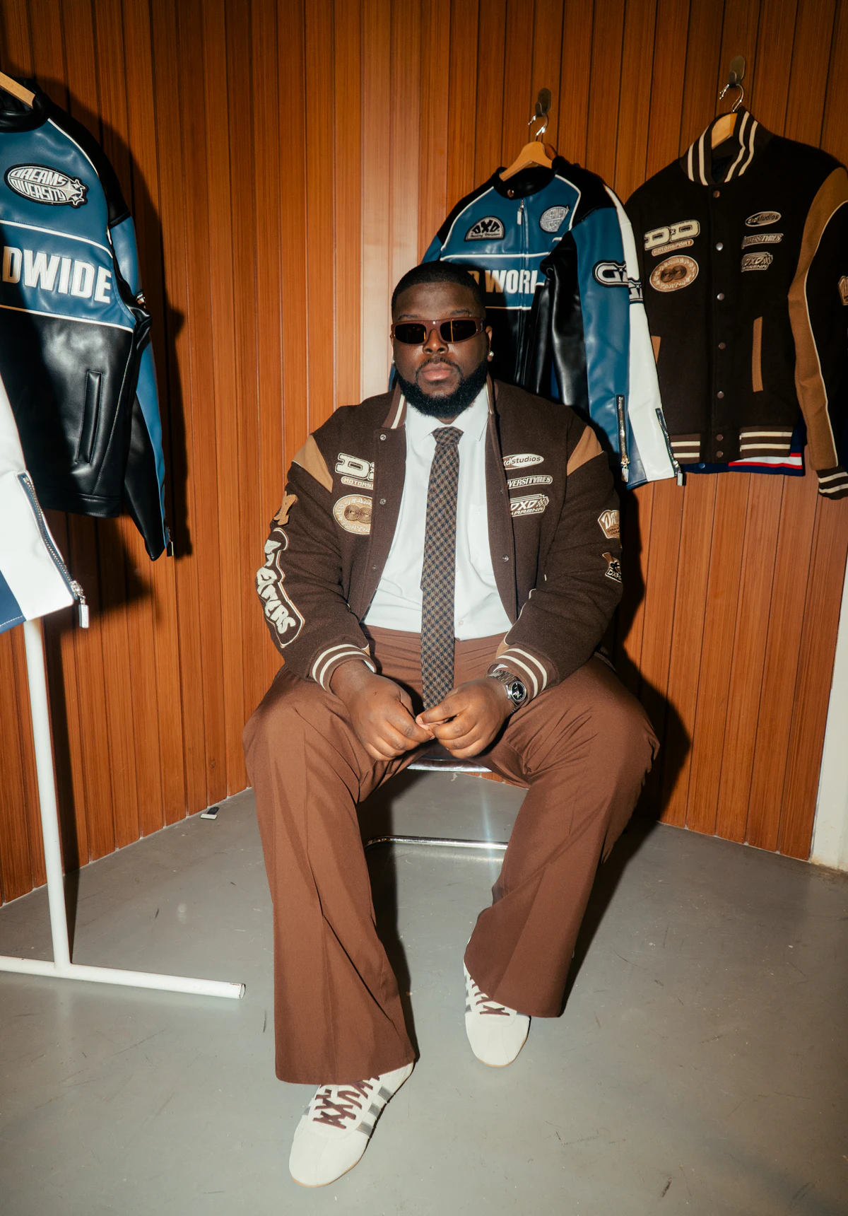 Custom letterman jacket worn, showing ribbed knit trim and patch detailing