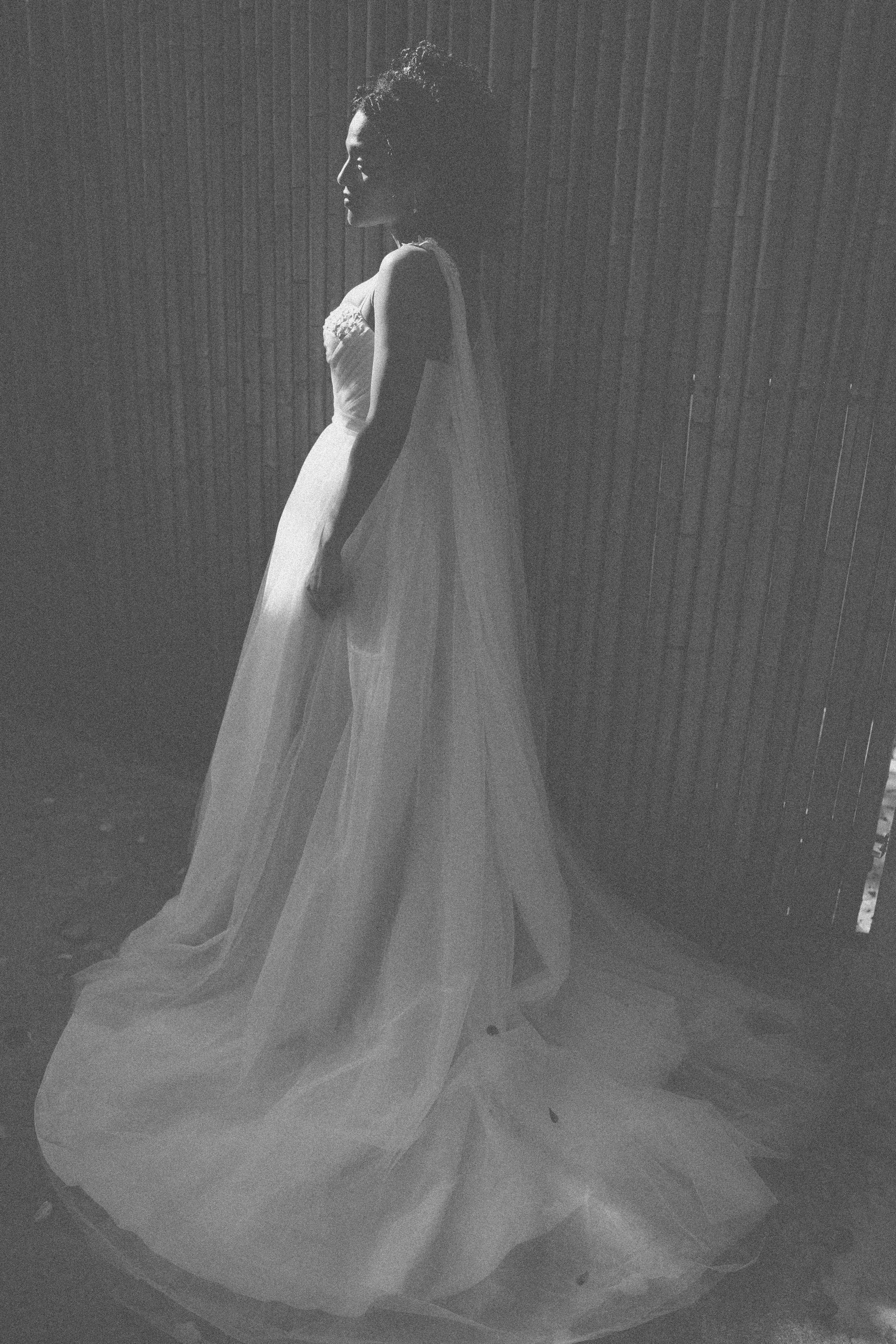 Sposa in abito da sposa fluente su uno sfondo texturizzato