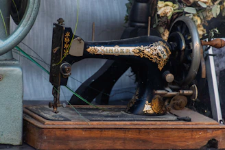 Antique black singer sewing machine on wooden base
