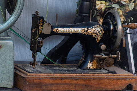 Antique black singer sewing machine on wooden base