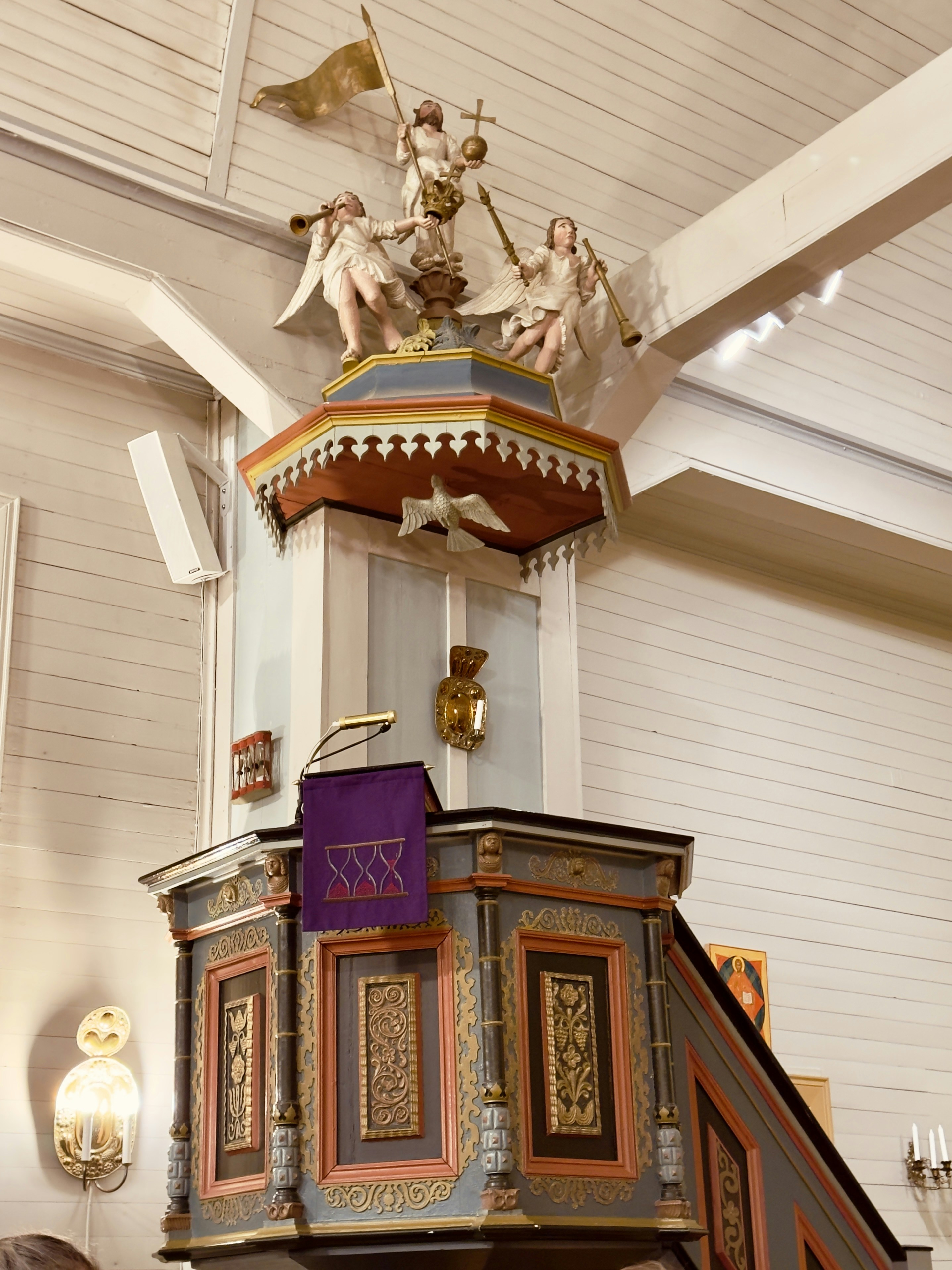 Ornate church pulpit with religious figures at top