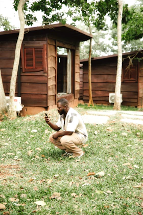 Man working in the field with mobile technology, West Africa