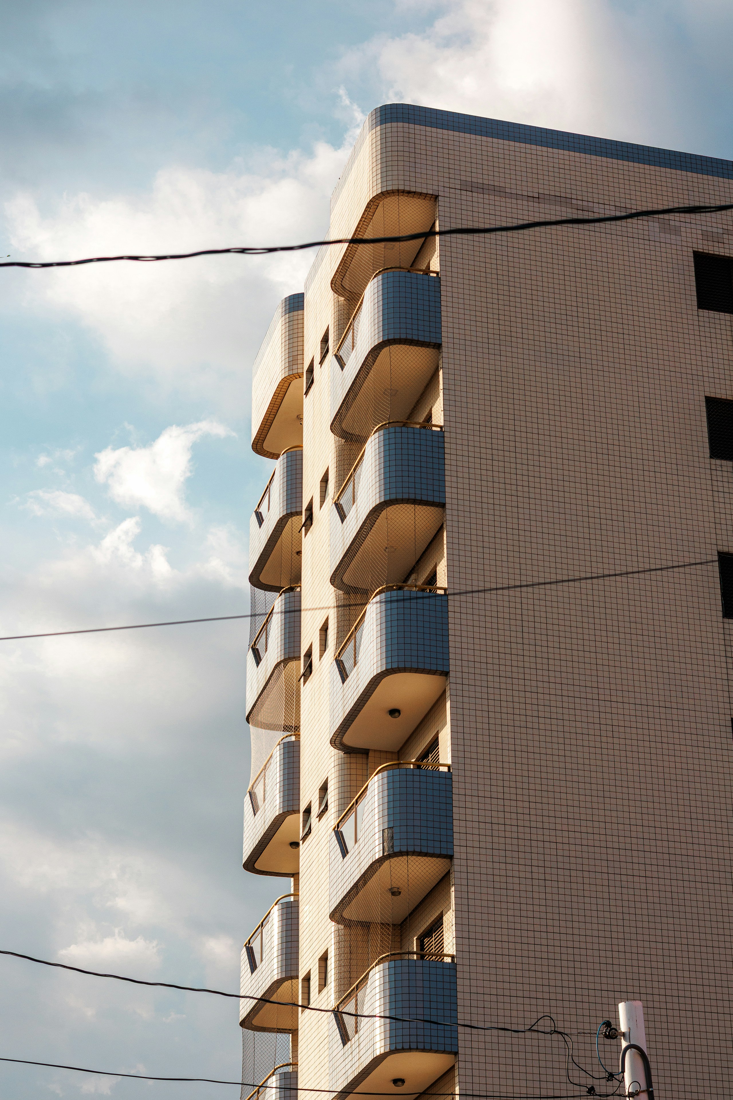 Modern apartment building with curved balconies against sky