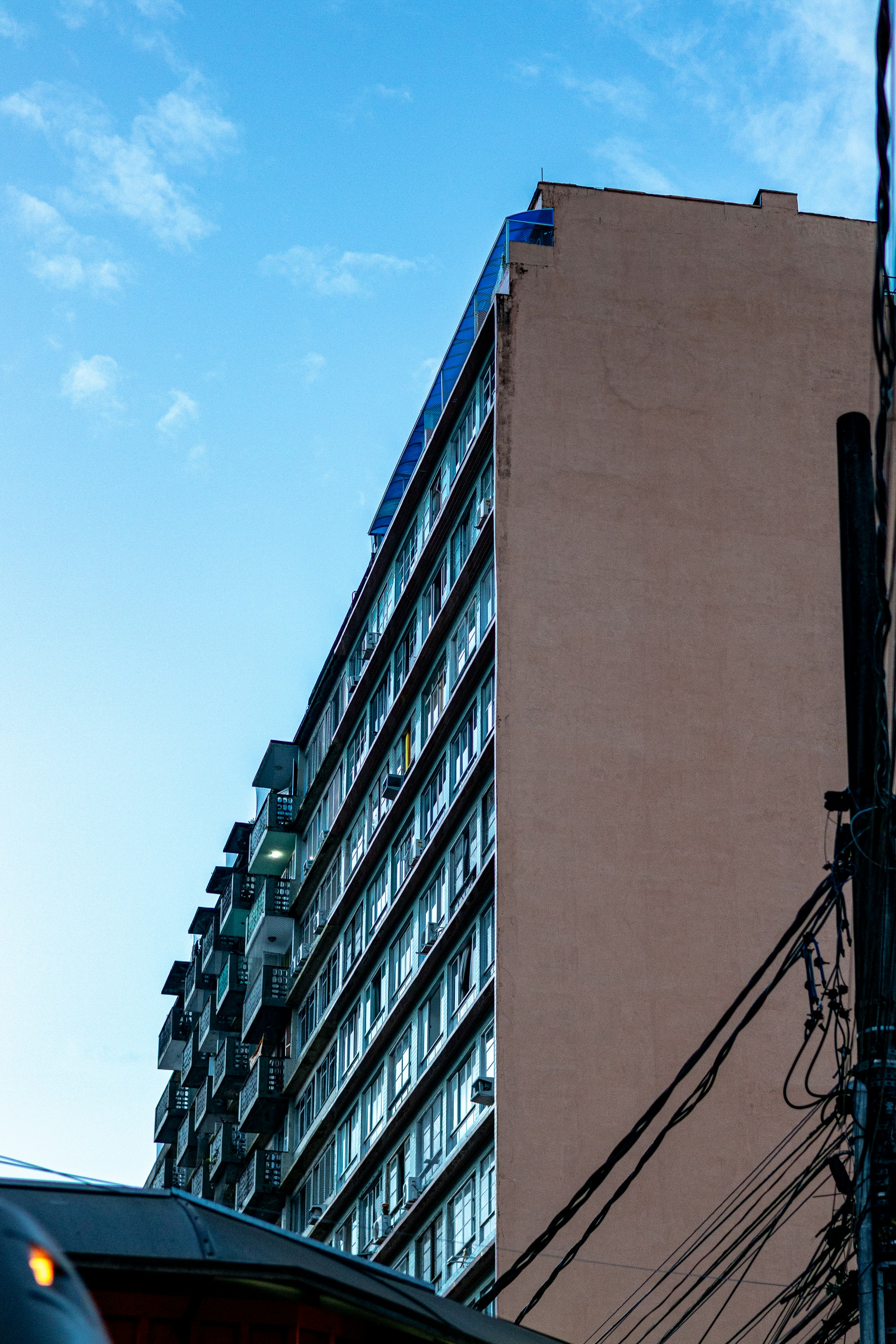 Tall apartment building against a blue sky