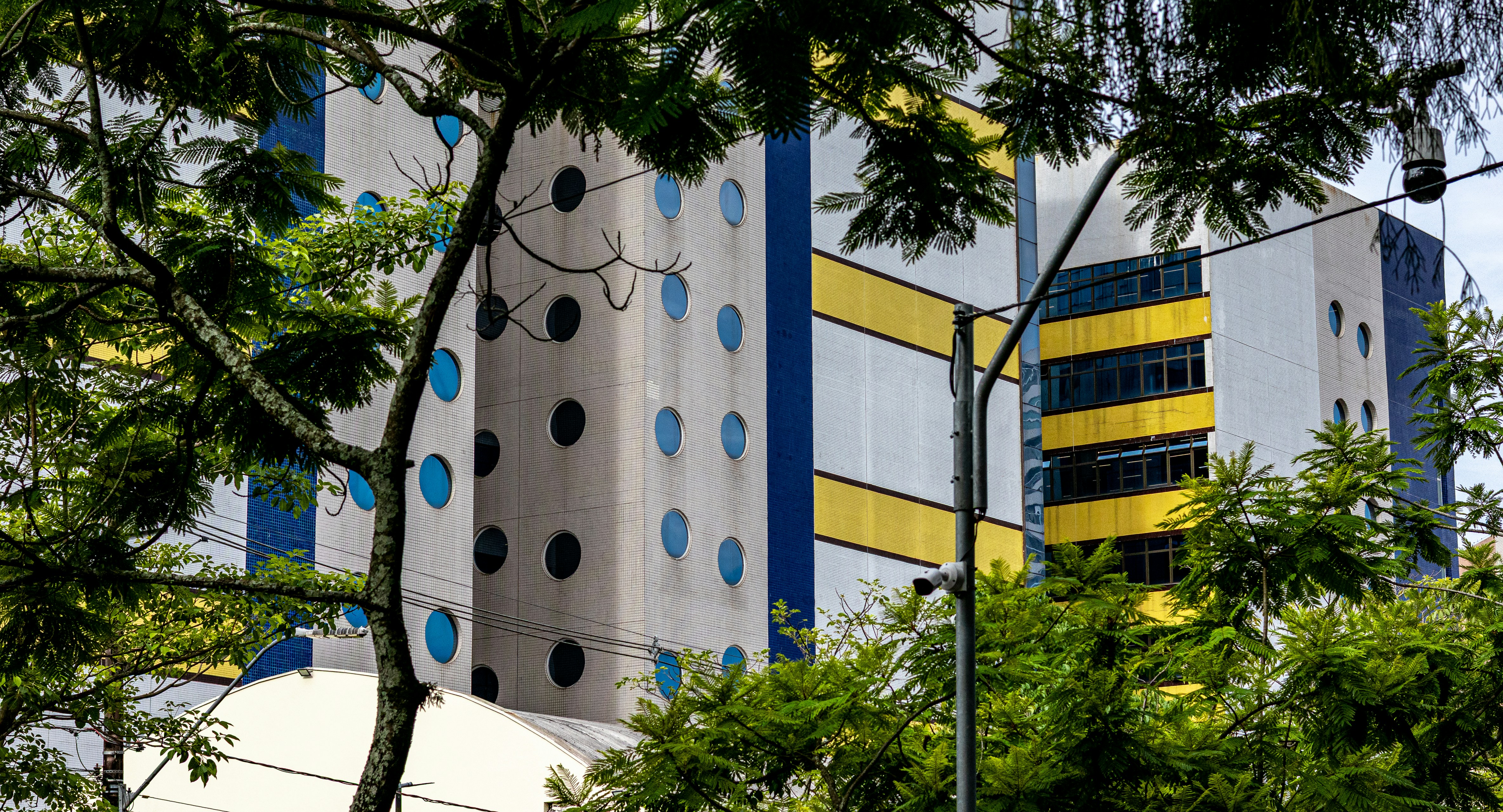 Modern building with blue polka dots and yellow accents.