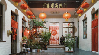 Traditional courtyard decorated with red lanterns and plants.