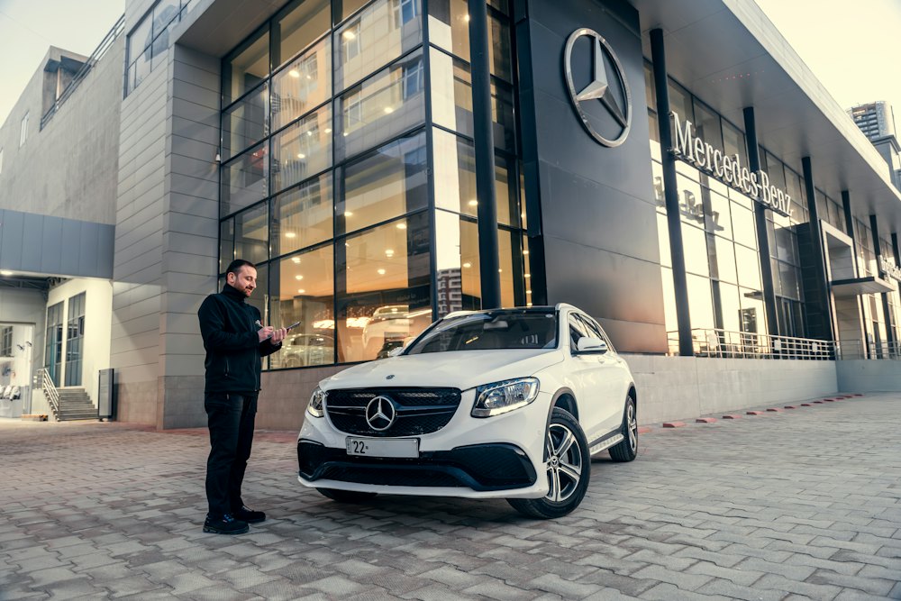 Vehicle owner with an SUV at a dealership after ownership transfer