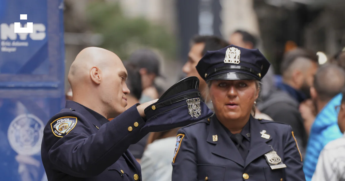 Police Page Two police officers in uniform standing outdoors. photo – Free City ...