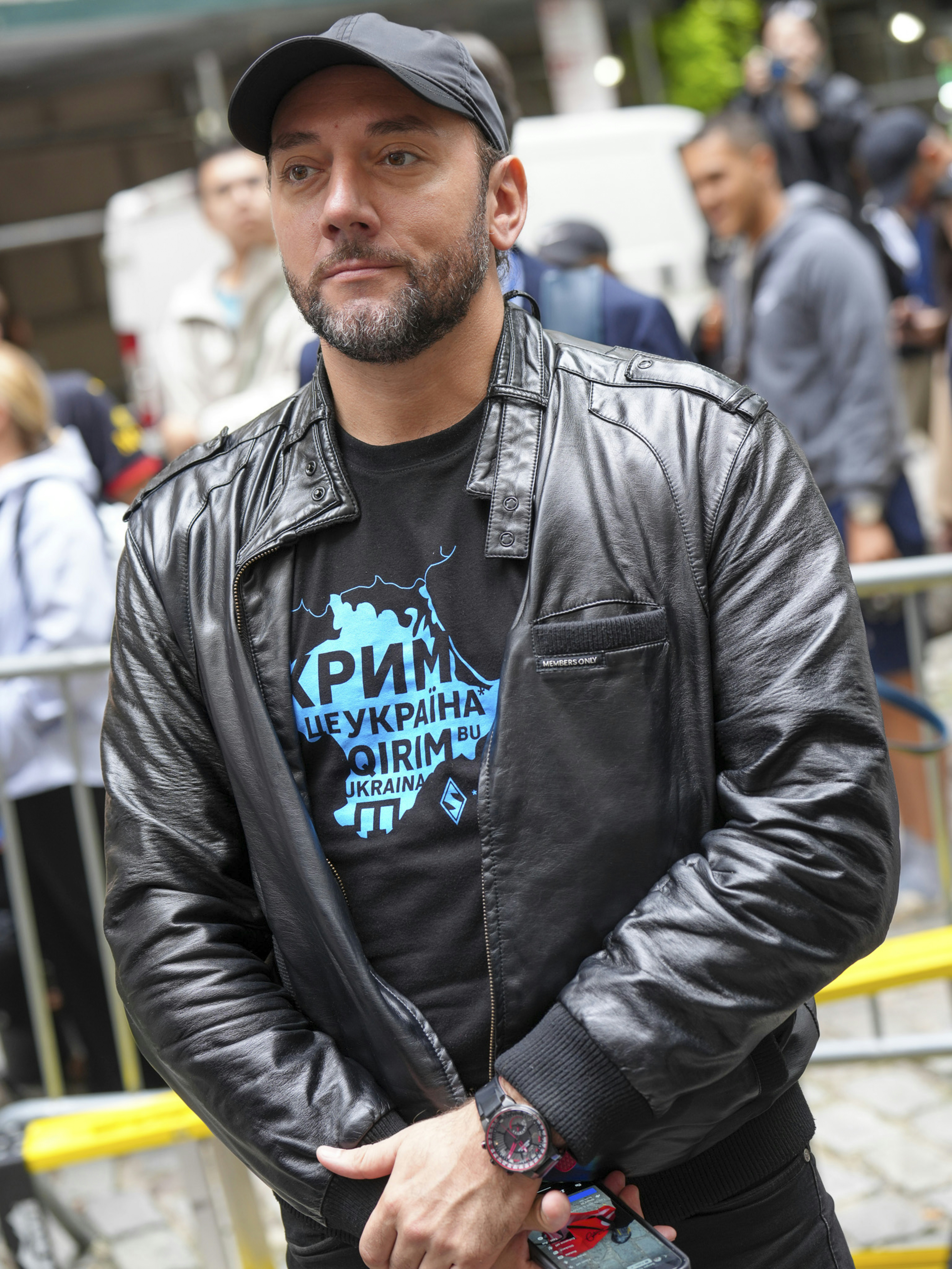 Man wearing a leather jacket and a cap