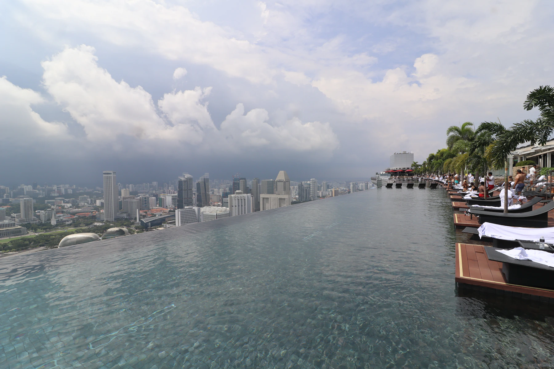 Guests relax along the Marina Bay Sands infinity pool above Singapore's skyline
