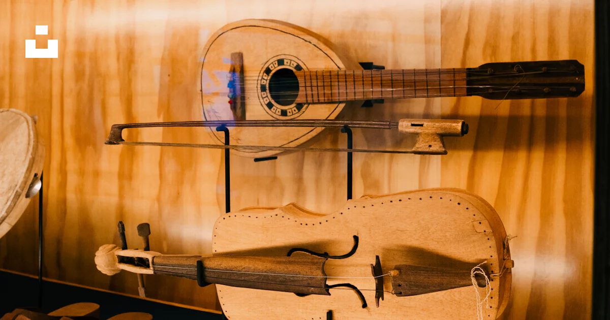 Small Double Stringed Instruments Two antique stringed instruments in a display case. photo – Free Violin ...