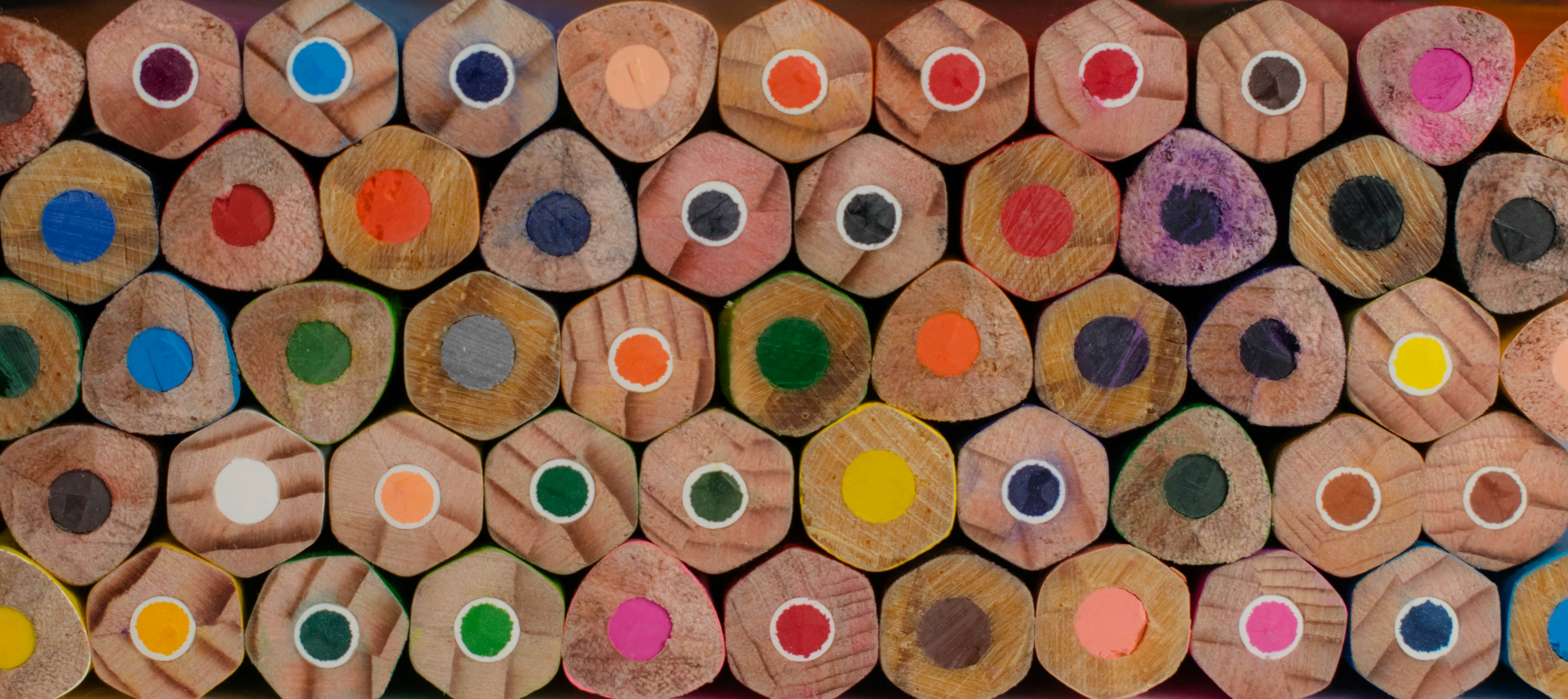 Primo piano delle punte delle matite colorate disposte in file.