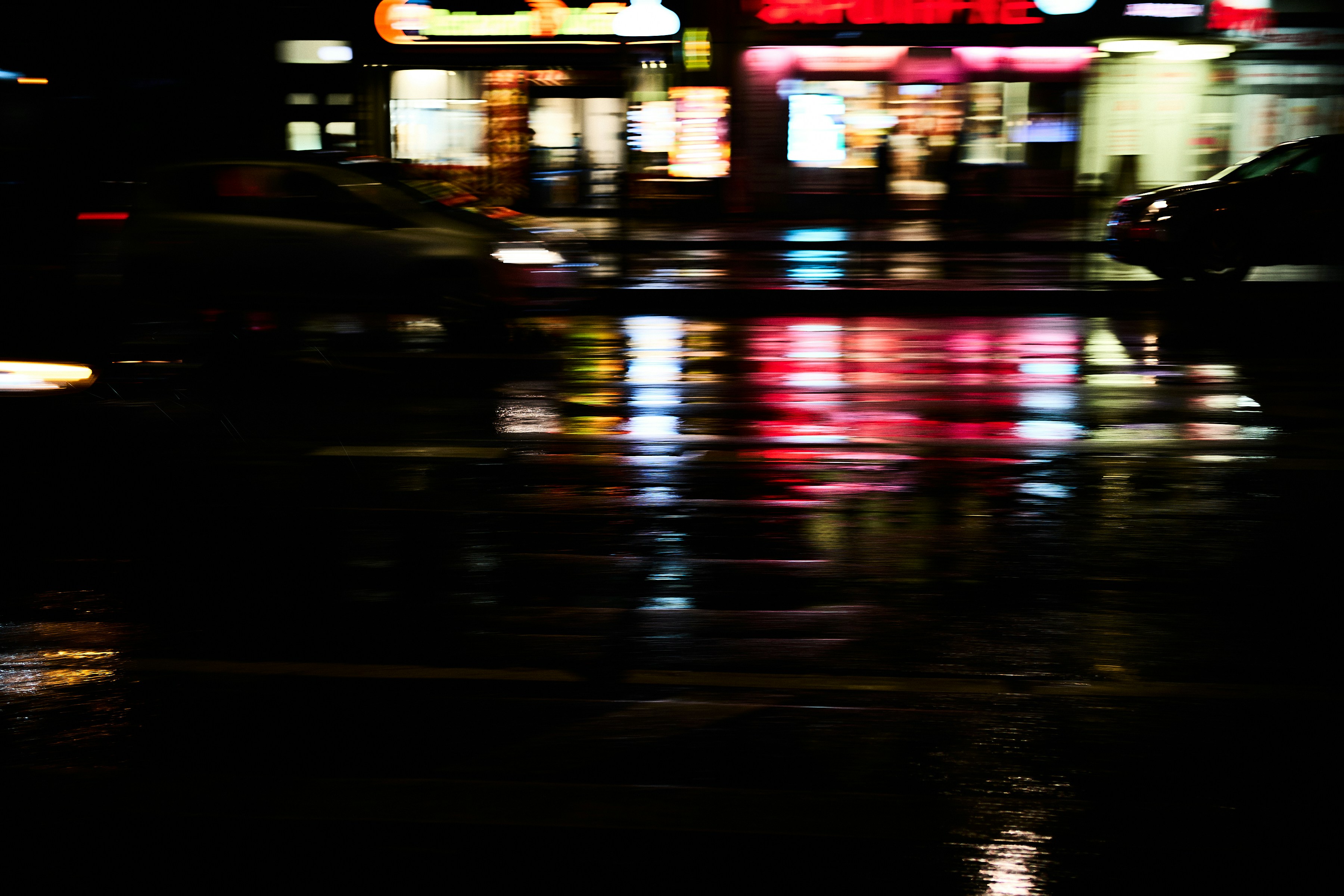 Wet city street at night with reflections