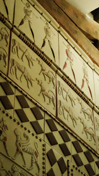 Ancient wall art depicting warriors and animals