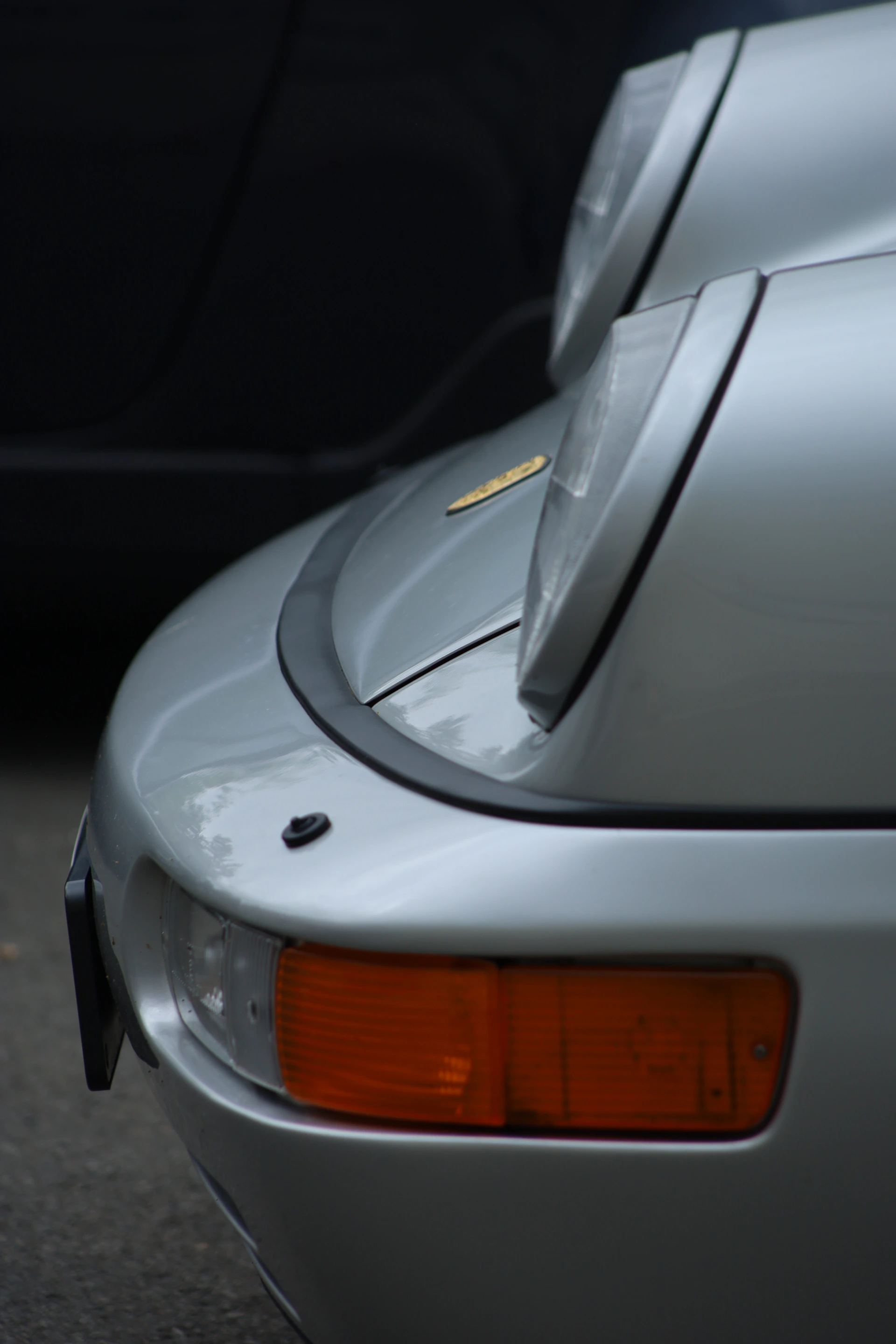 Close-up of a silver sports car's headlights