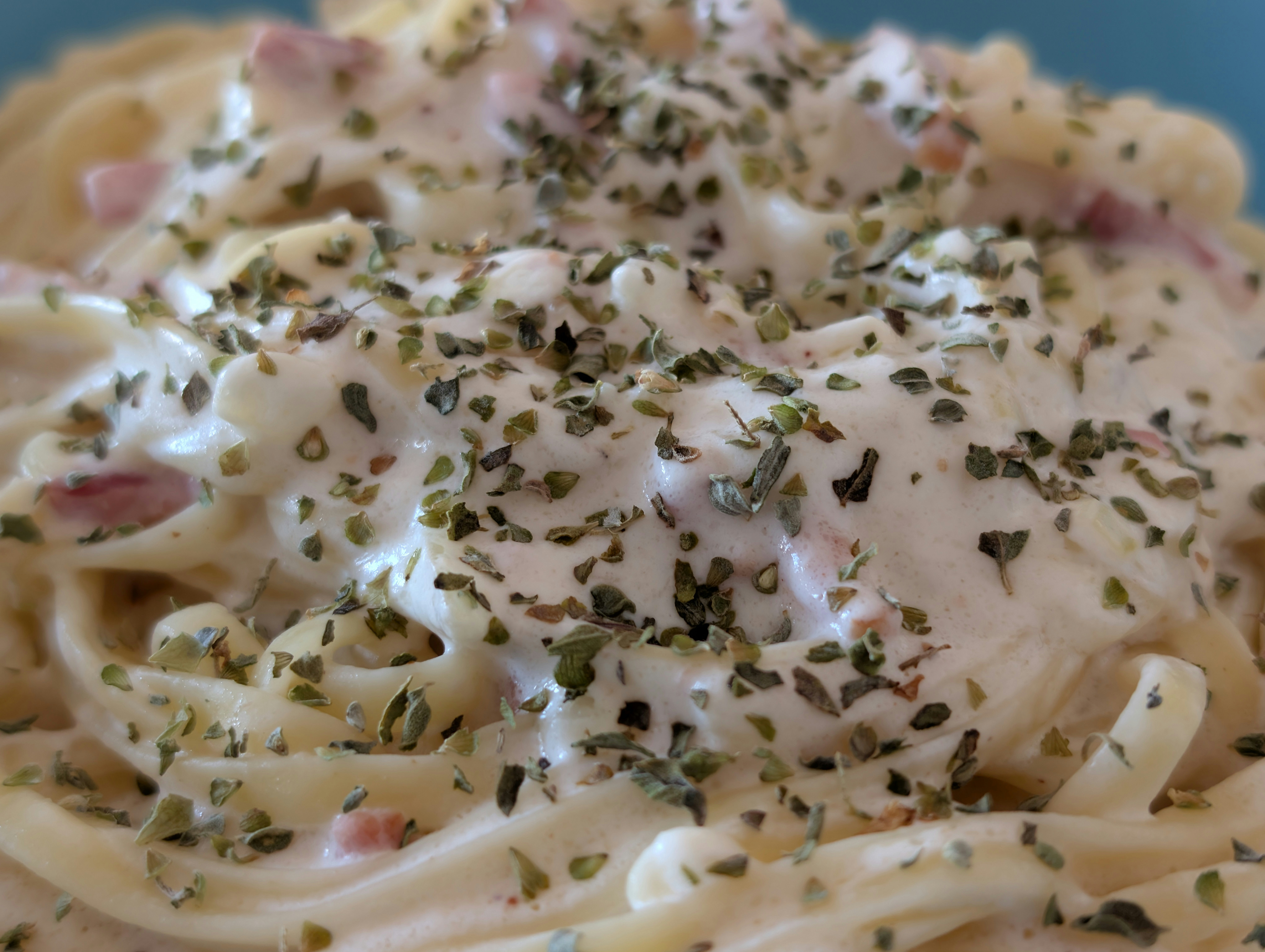 Creamy pasta with herbs and bacon bits