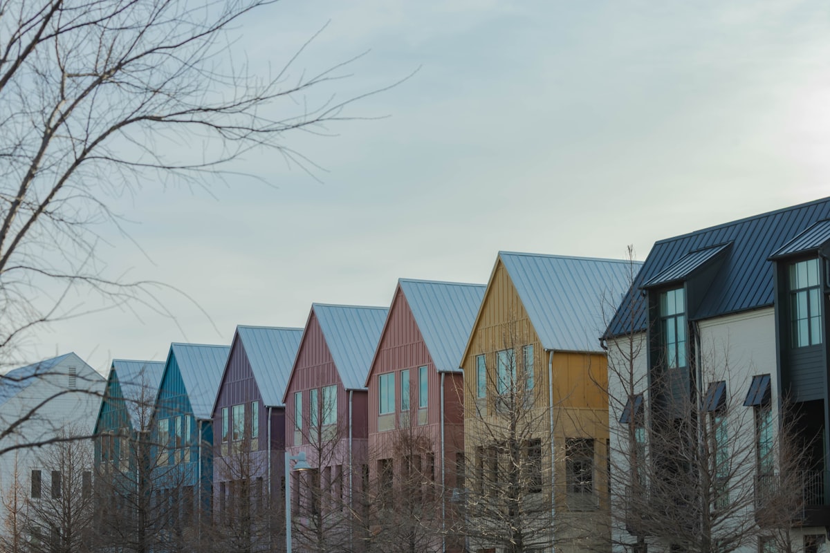Row of colorful modern houses under a cloudy sky