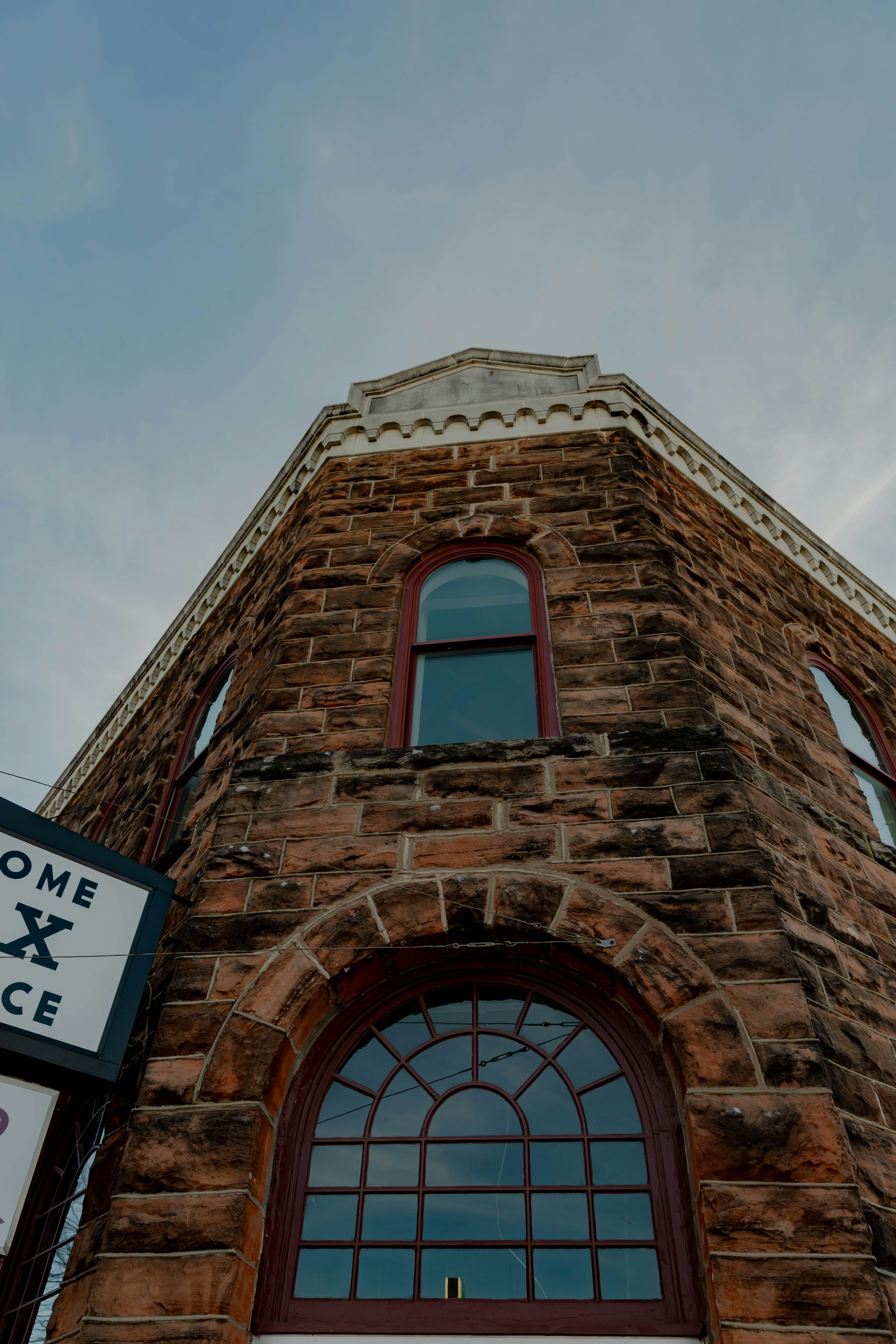 Stone building with arched windows against the sky