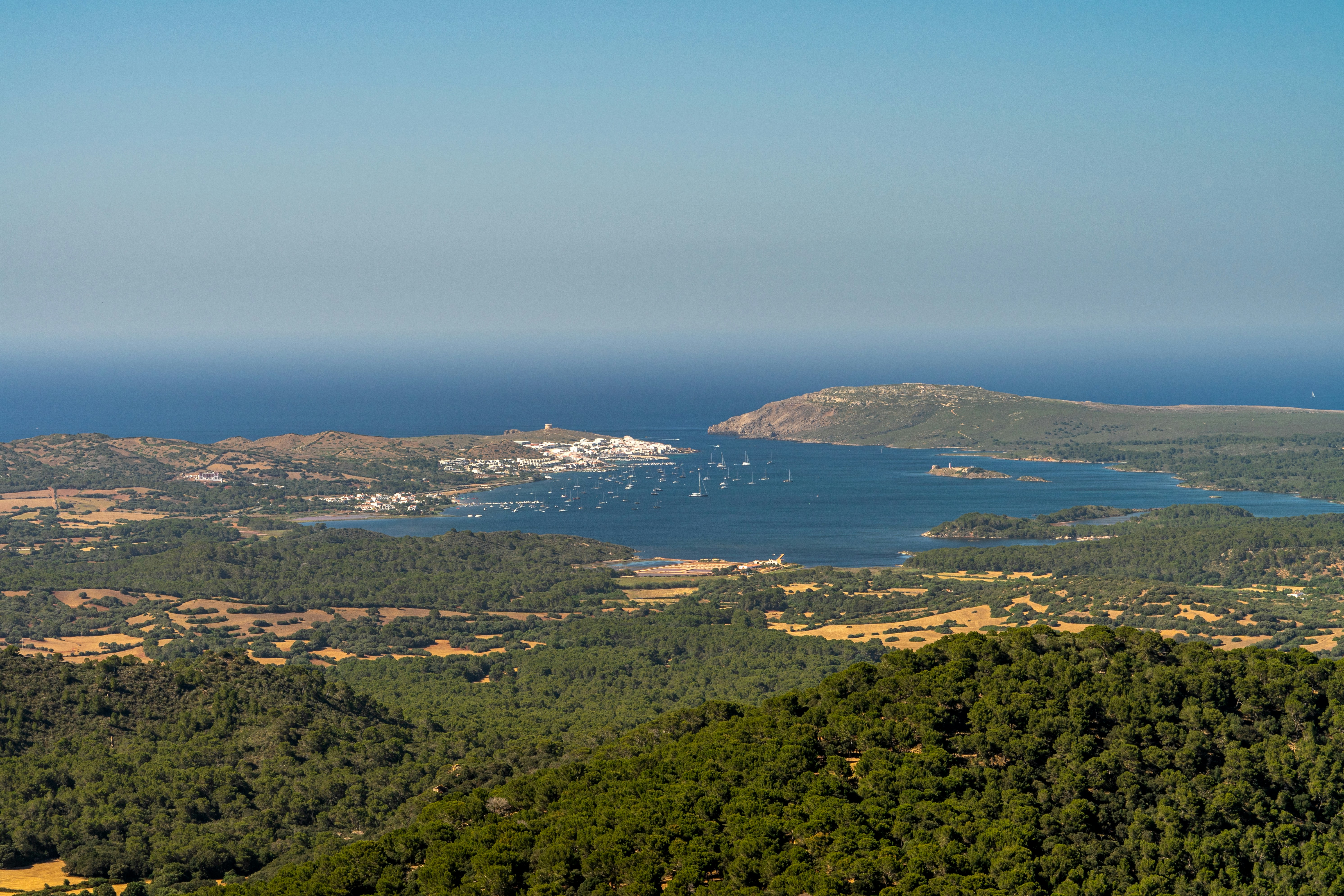 Coastal town with boats in a bay from above