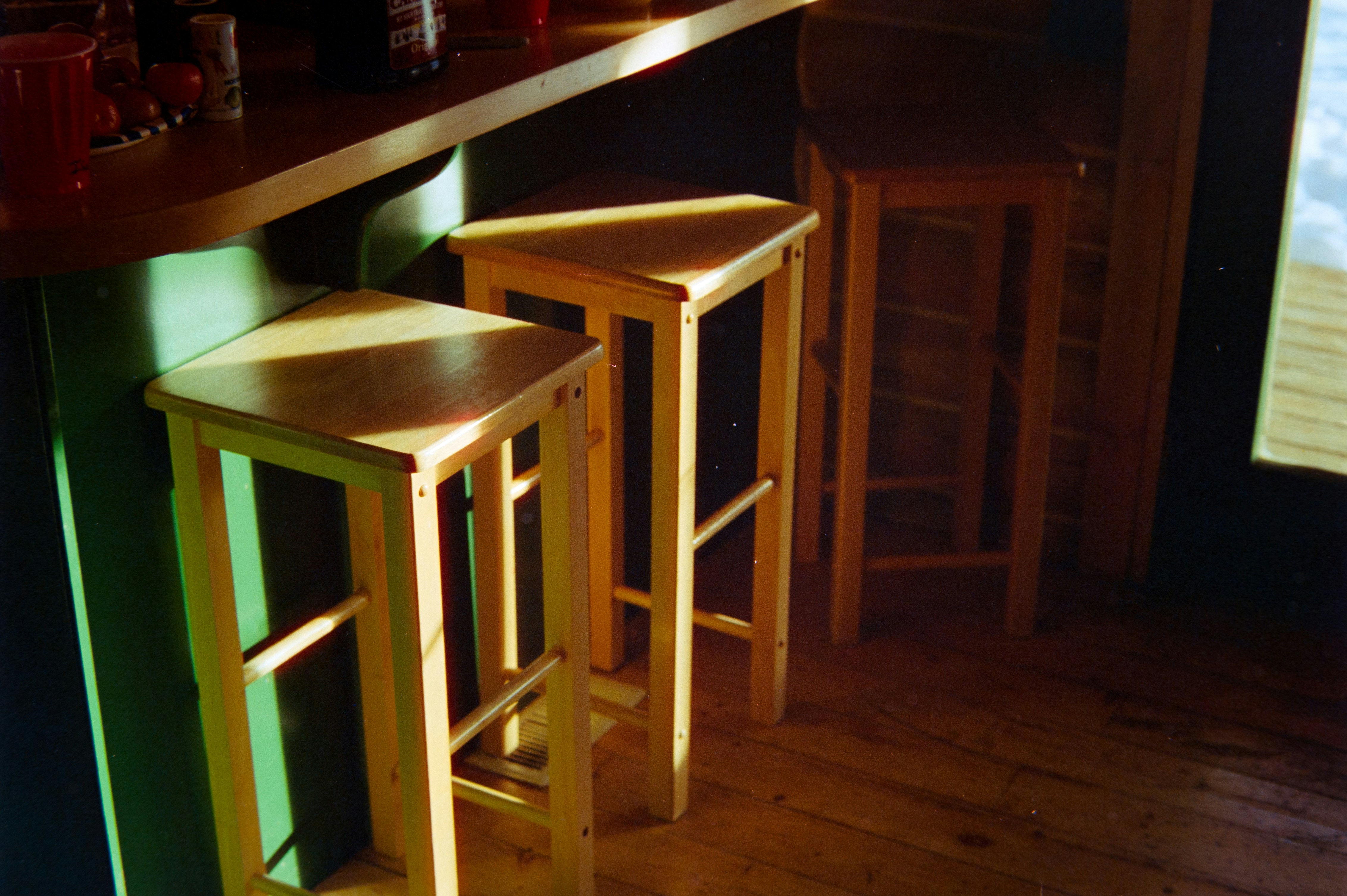 Two wooden bar stools at a counter