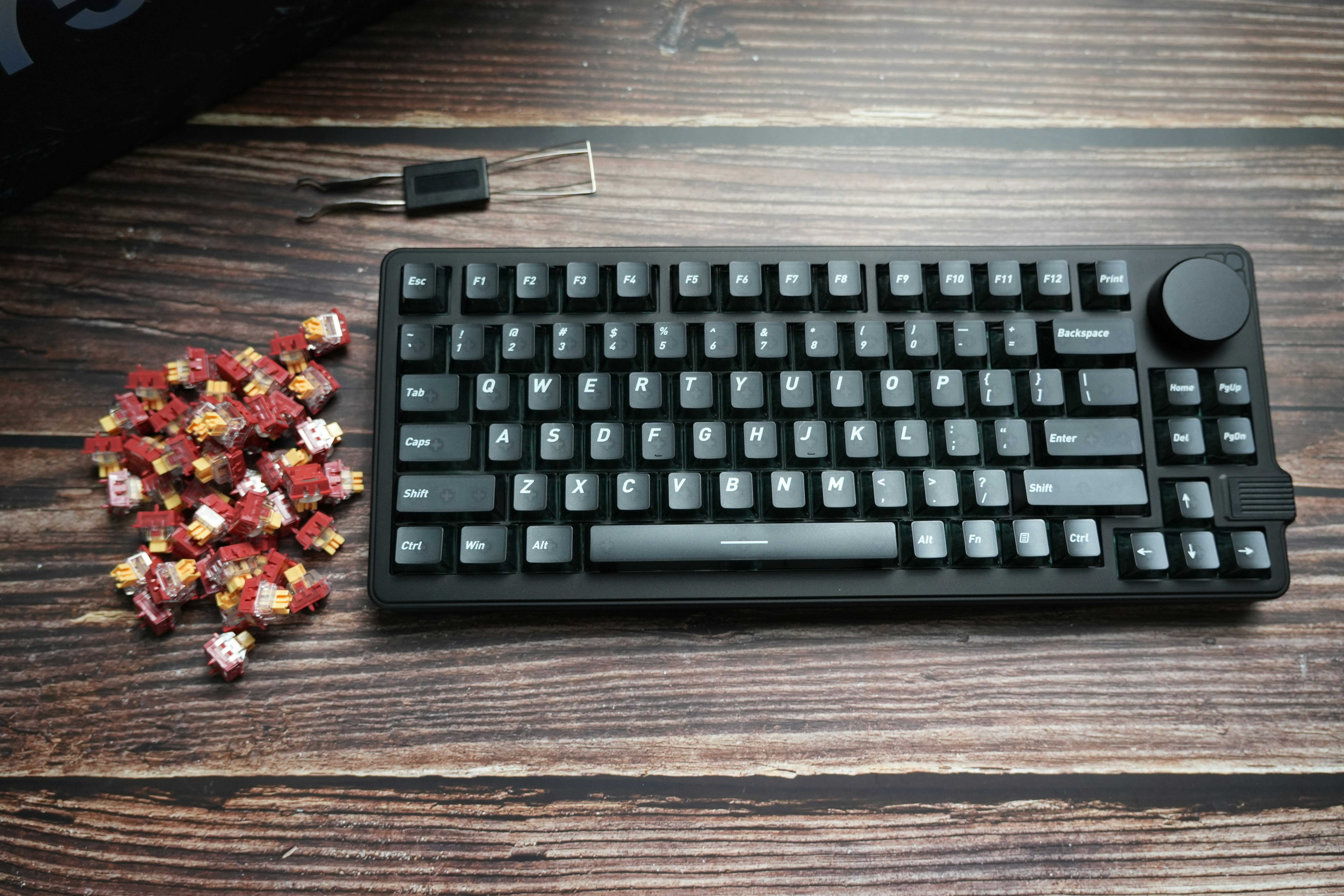 Black mechanical keyboard with rose buds and tools