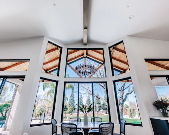 Modern dining room with large windows and chandelier