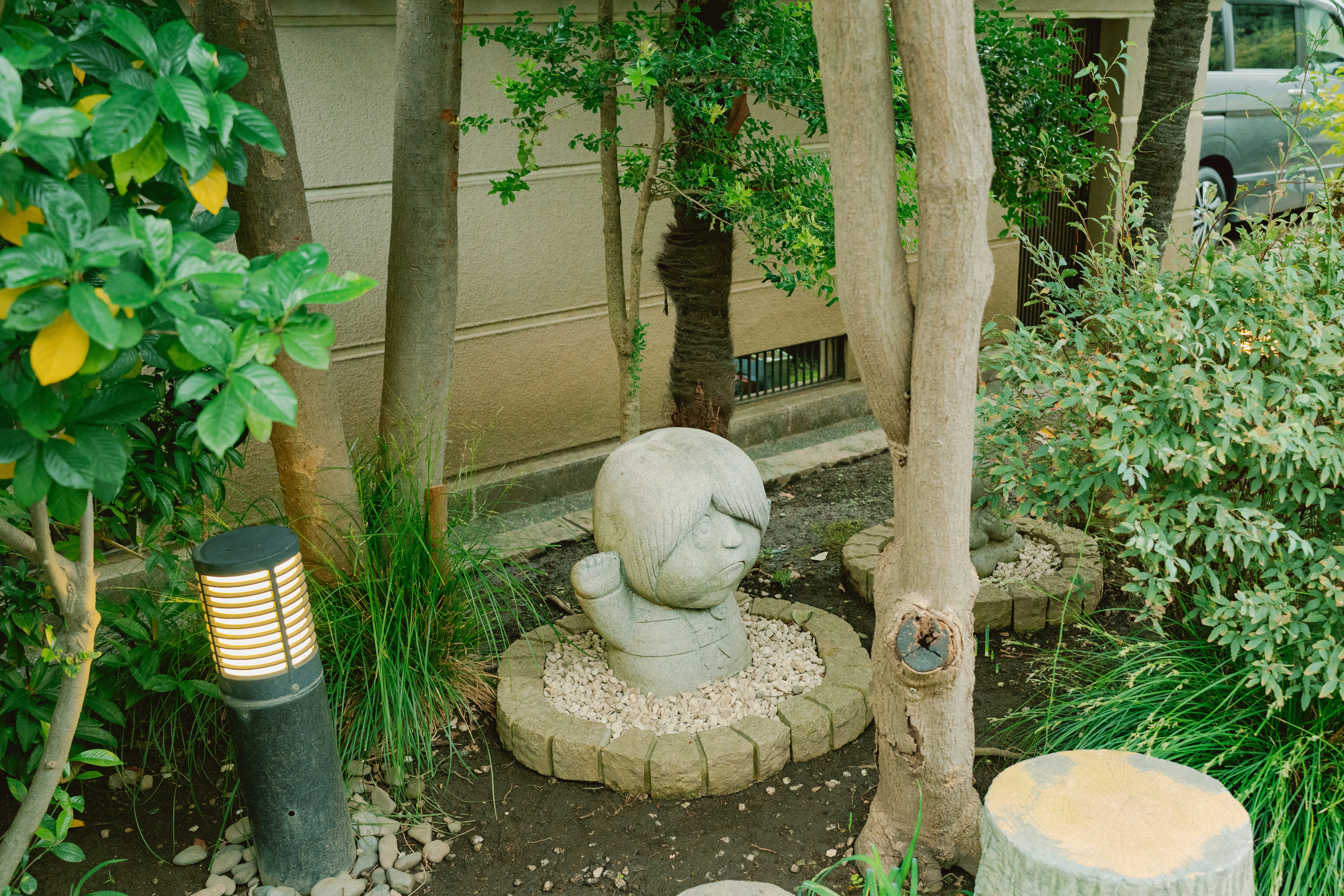Stone statue of a child in a garden