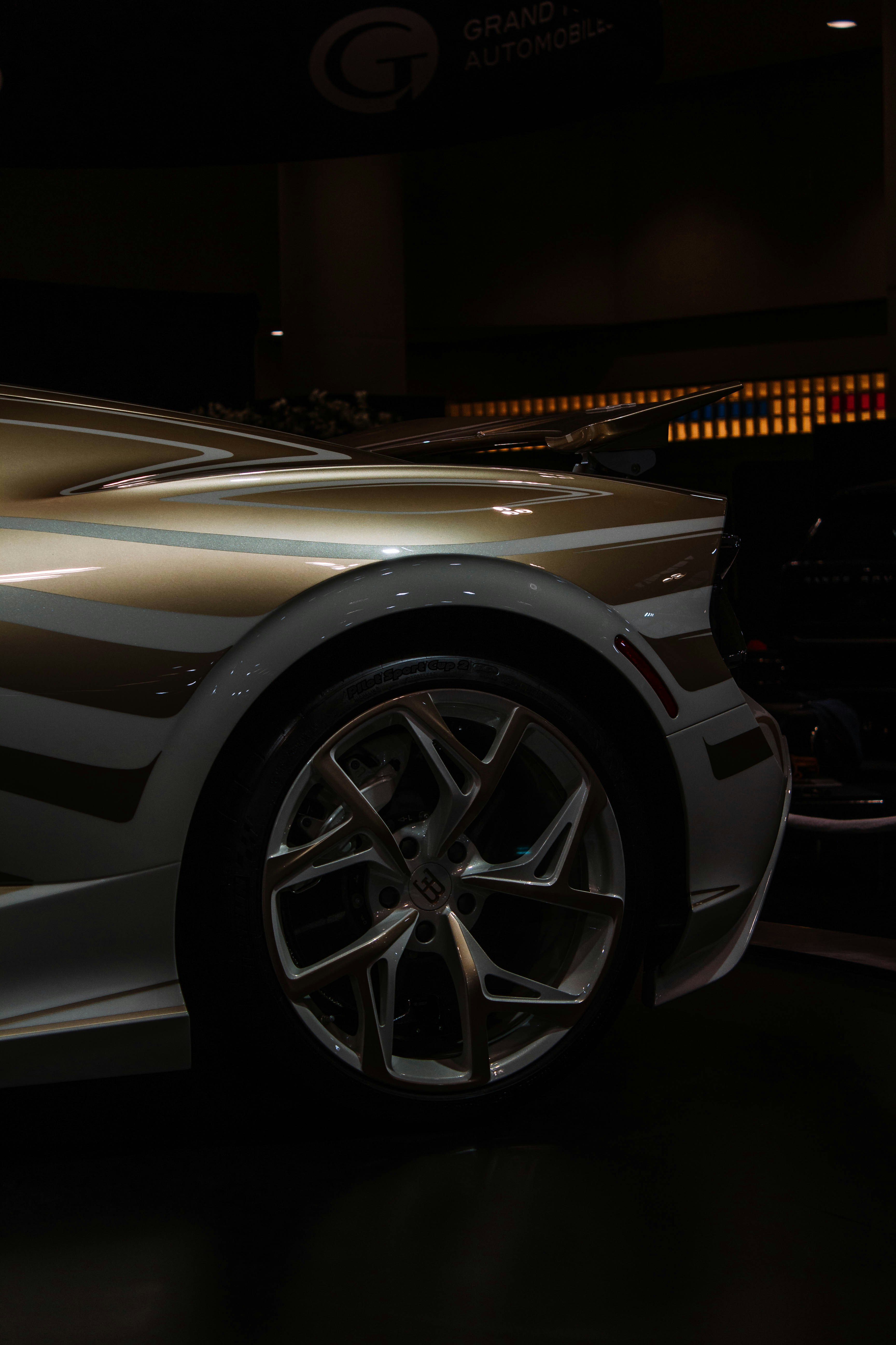 Close-up of a luxury car's wheel and fender.