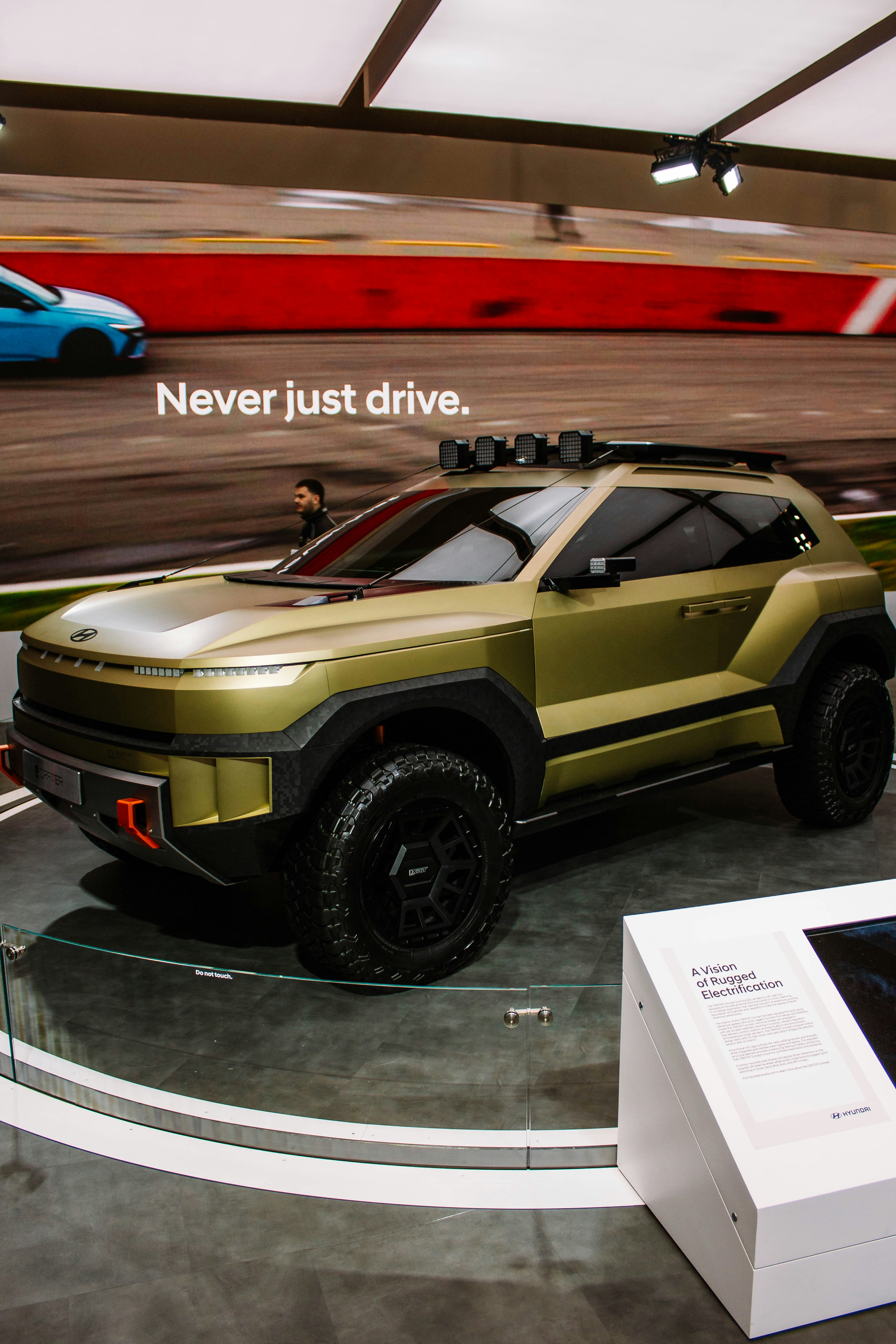 A futuristic gold suv with off-road tires.