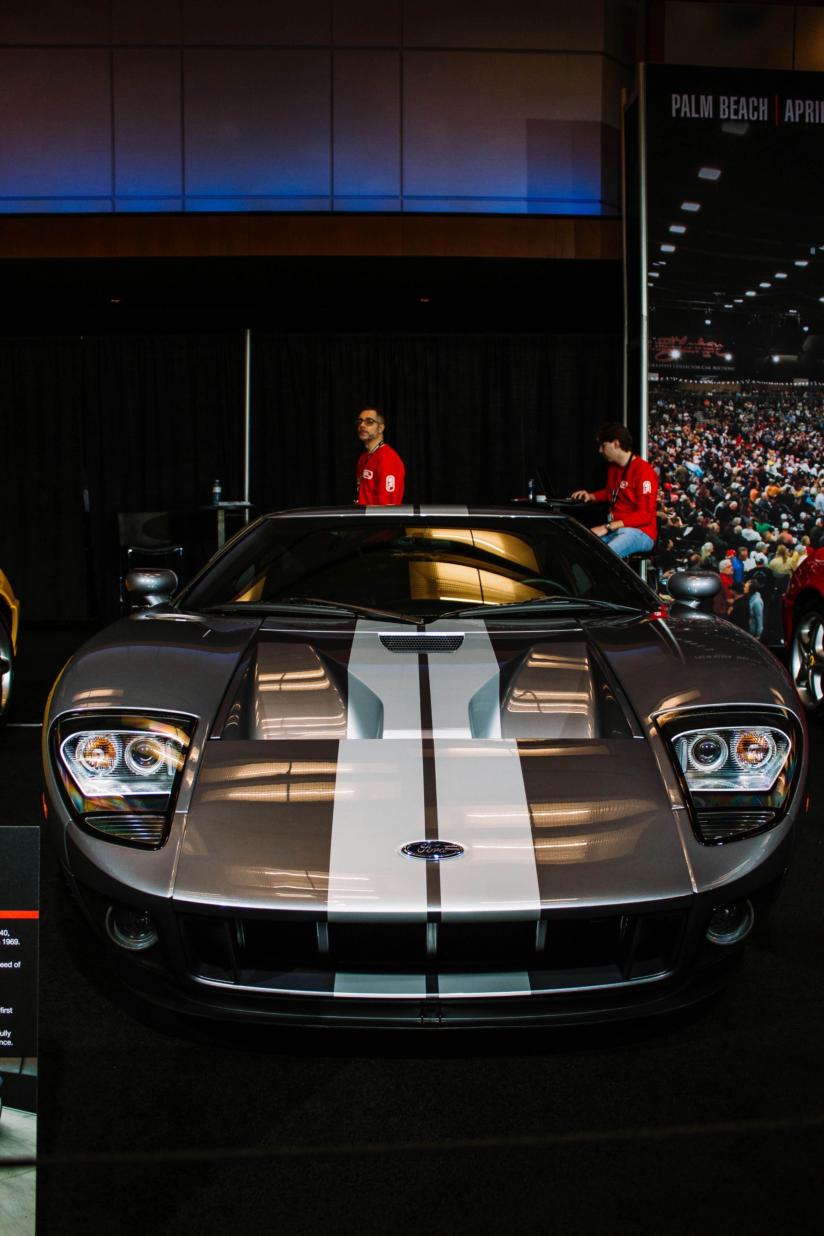 A silver ford gt with white racing stripes