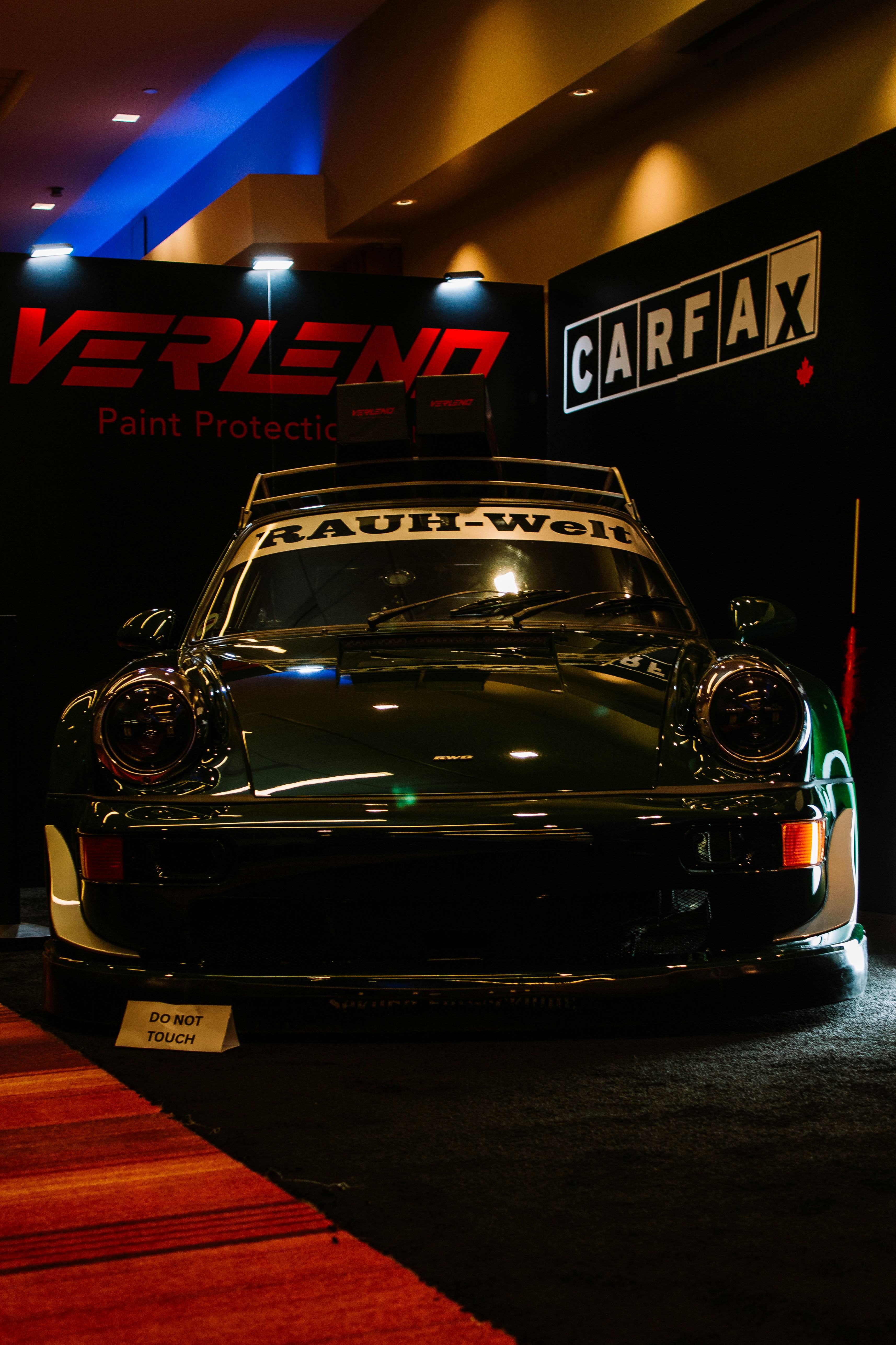 Dark green porsche 911 rwb with rauh-wolf text on roof.