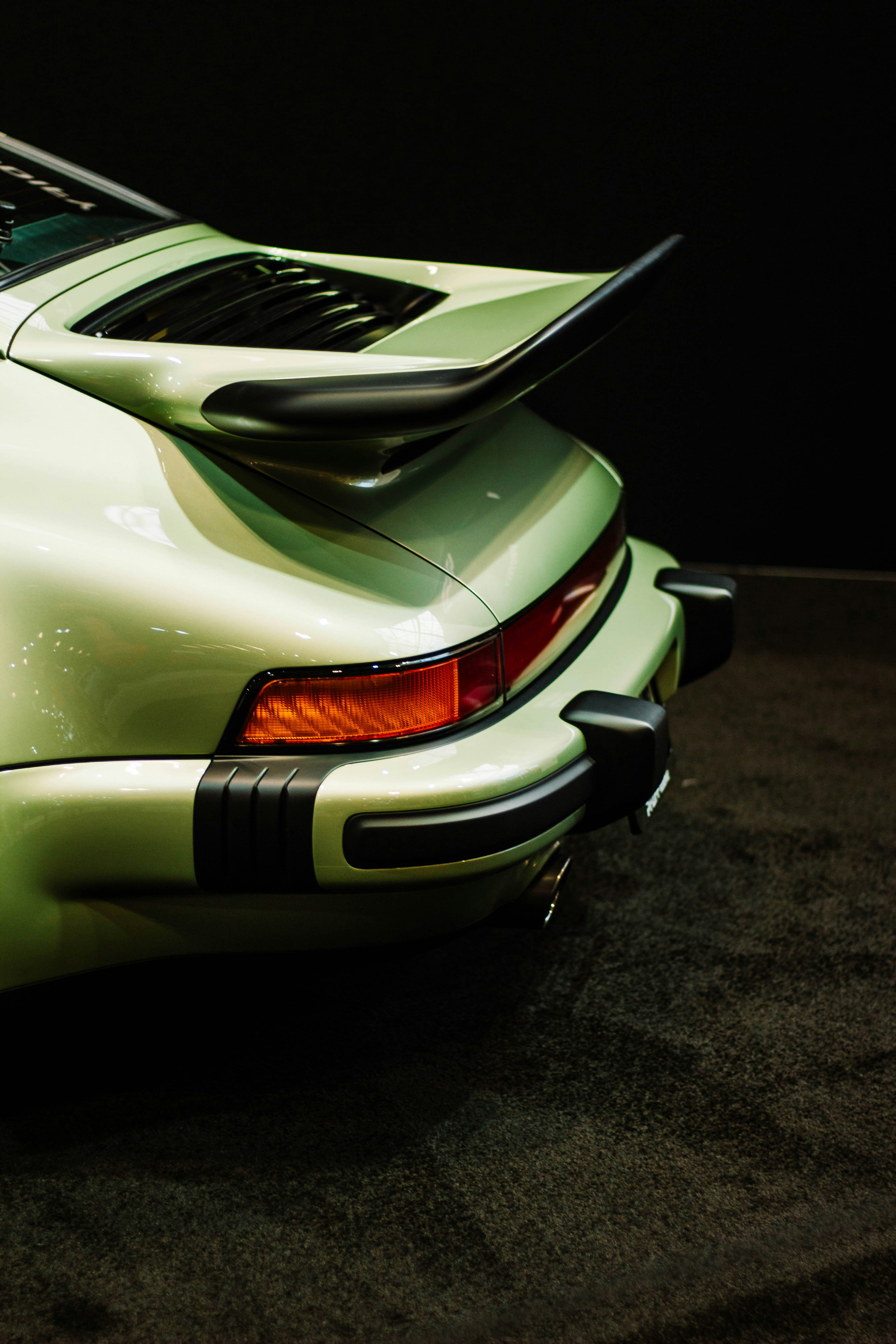 Rear view of a vintage light green sports car