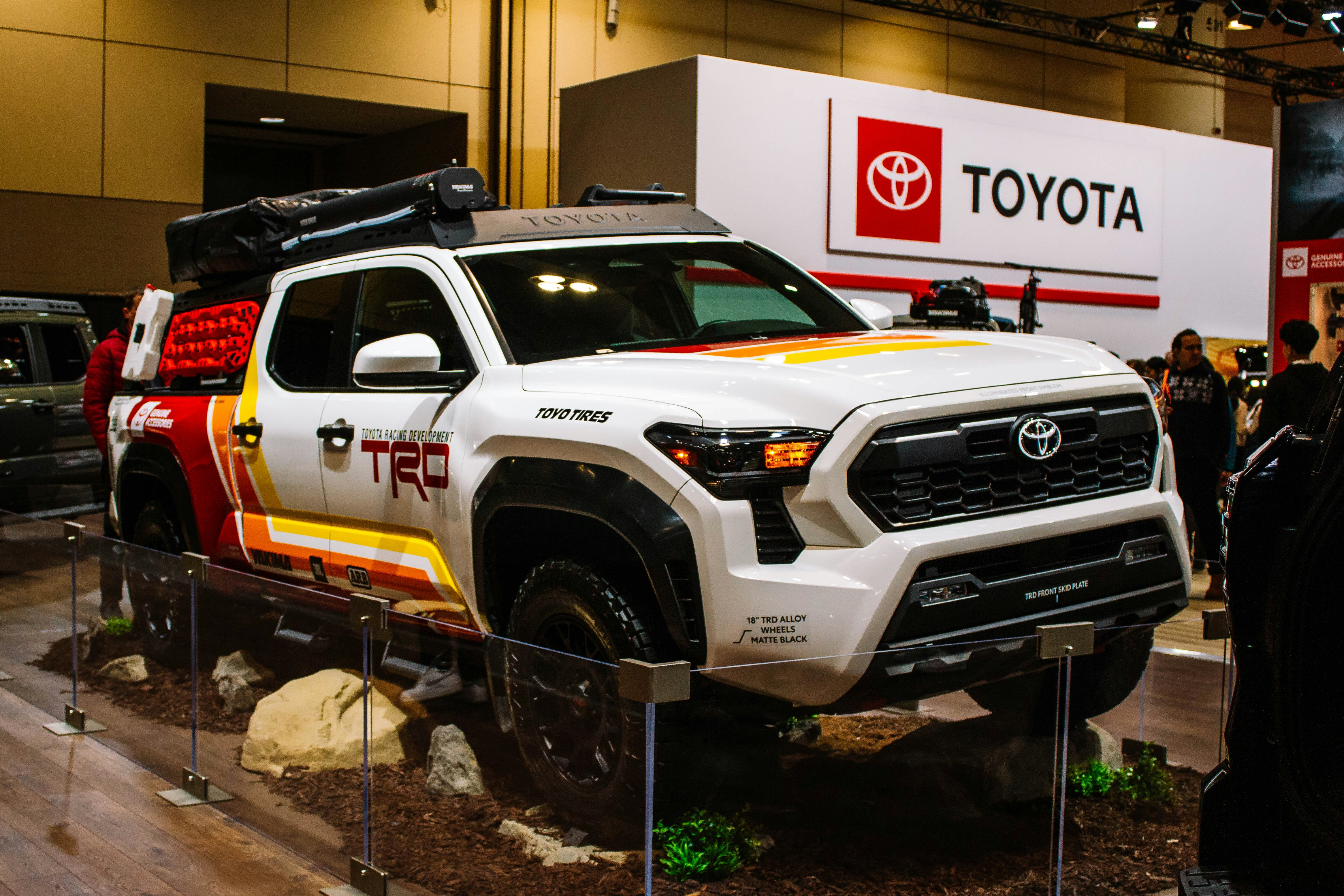 White toyota trd truck with colorful graphics on display