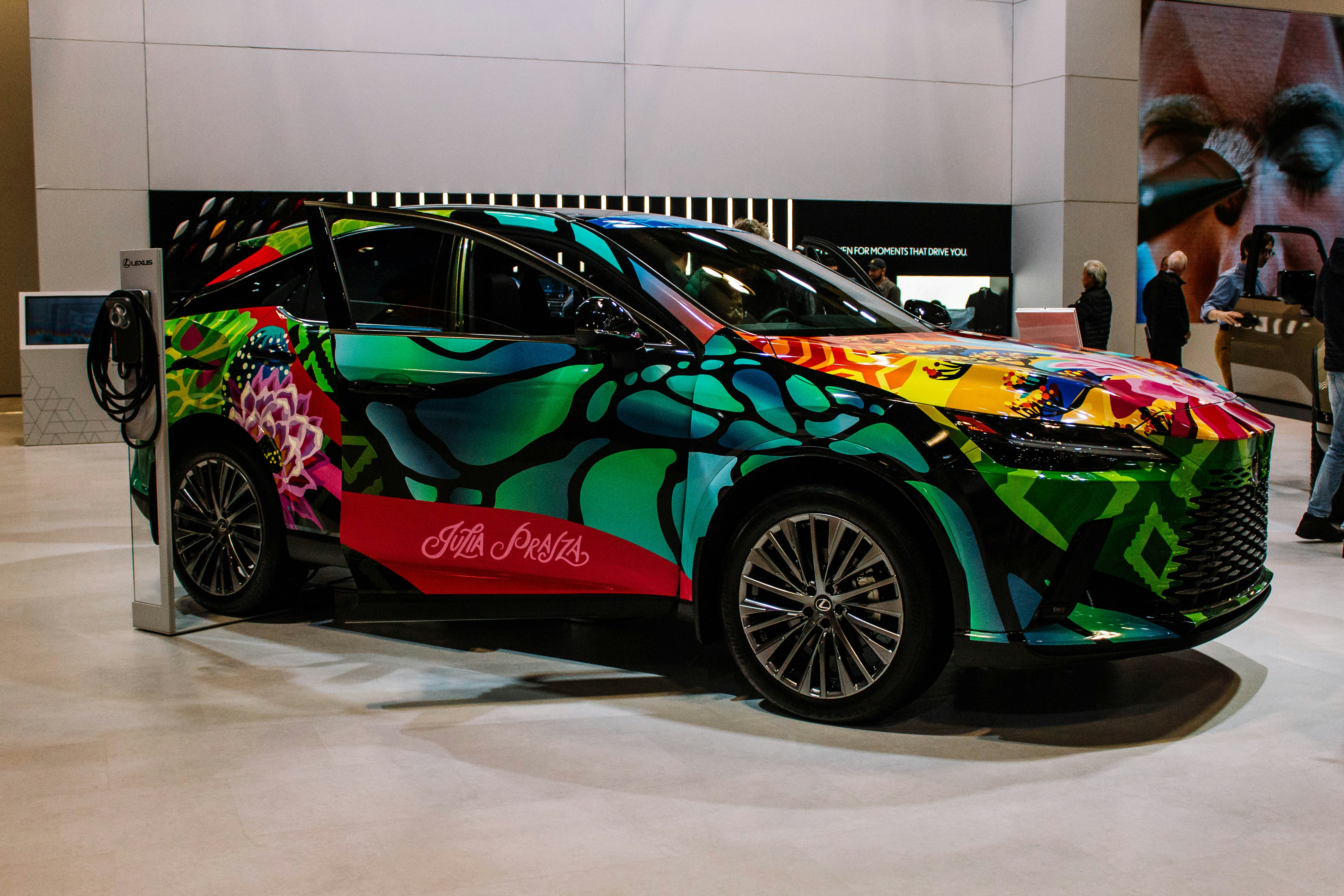 A car with a vibrant, abstract art wrap