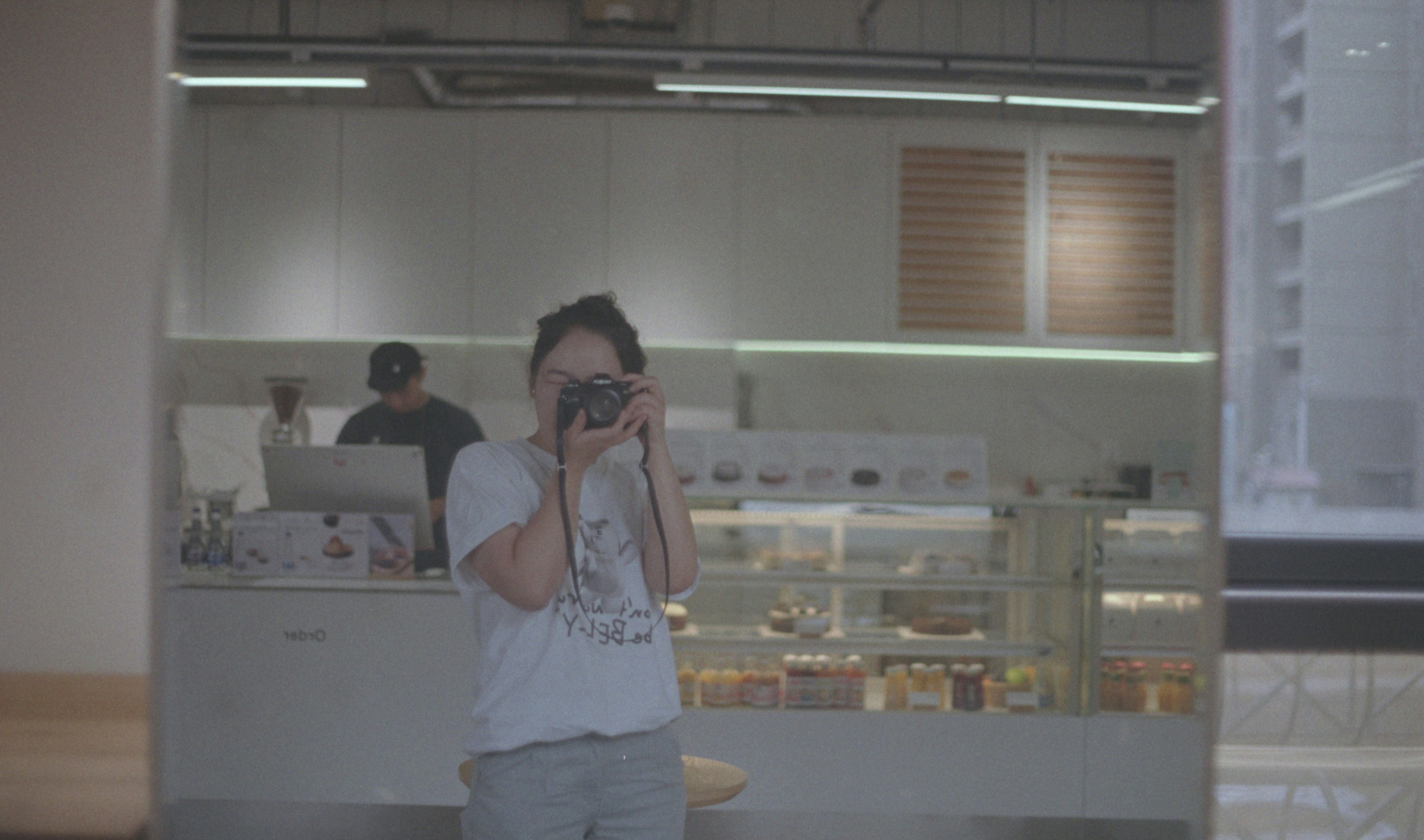 Woman taking a picture with a vintage camera