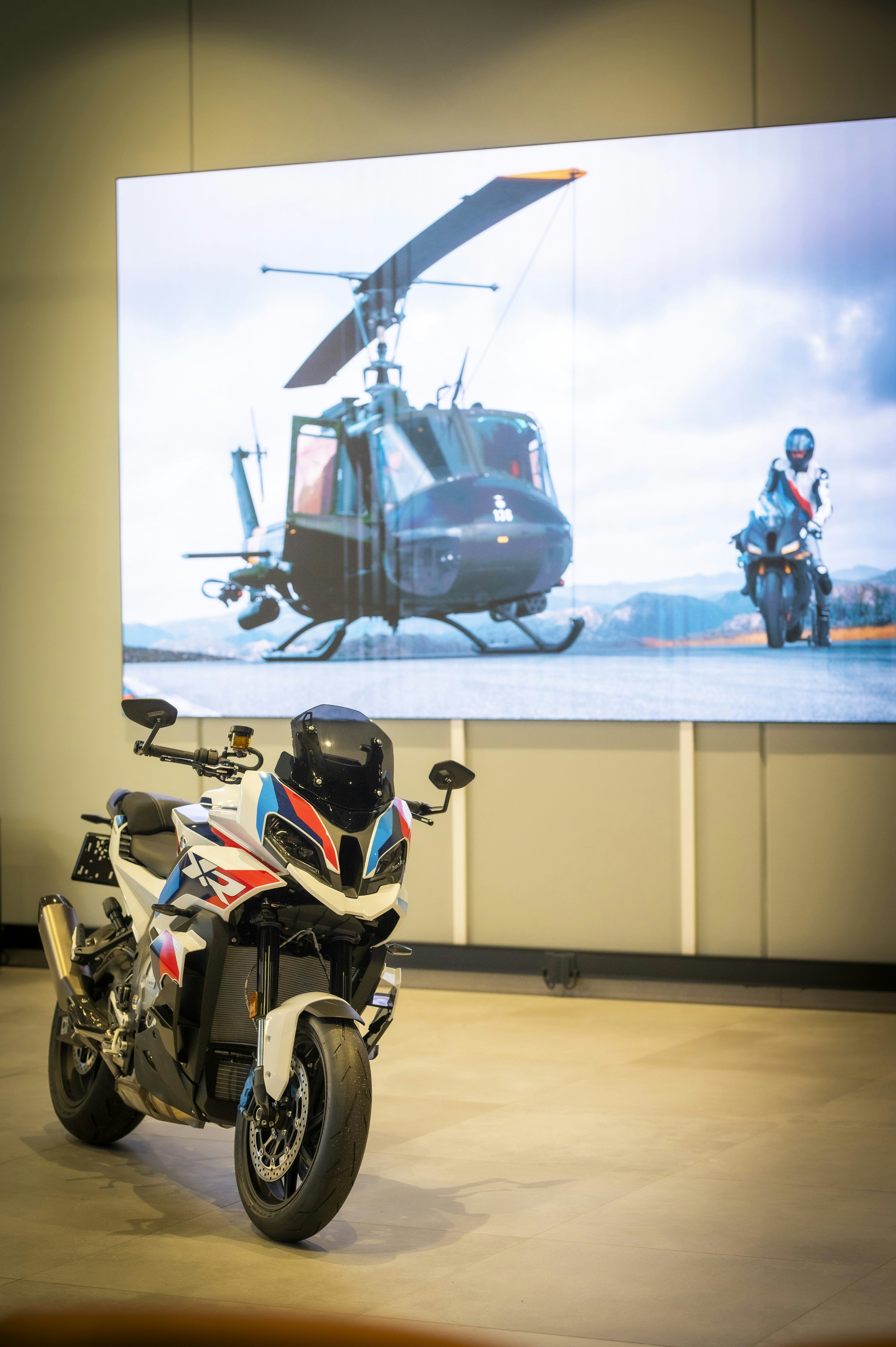 Motorcycle displayed with helicopter and rider backdrop
